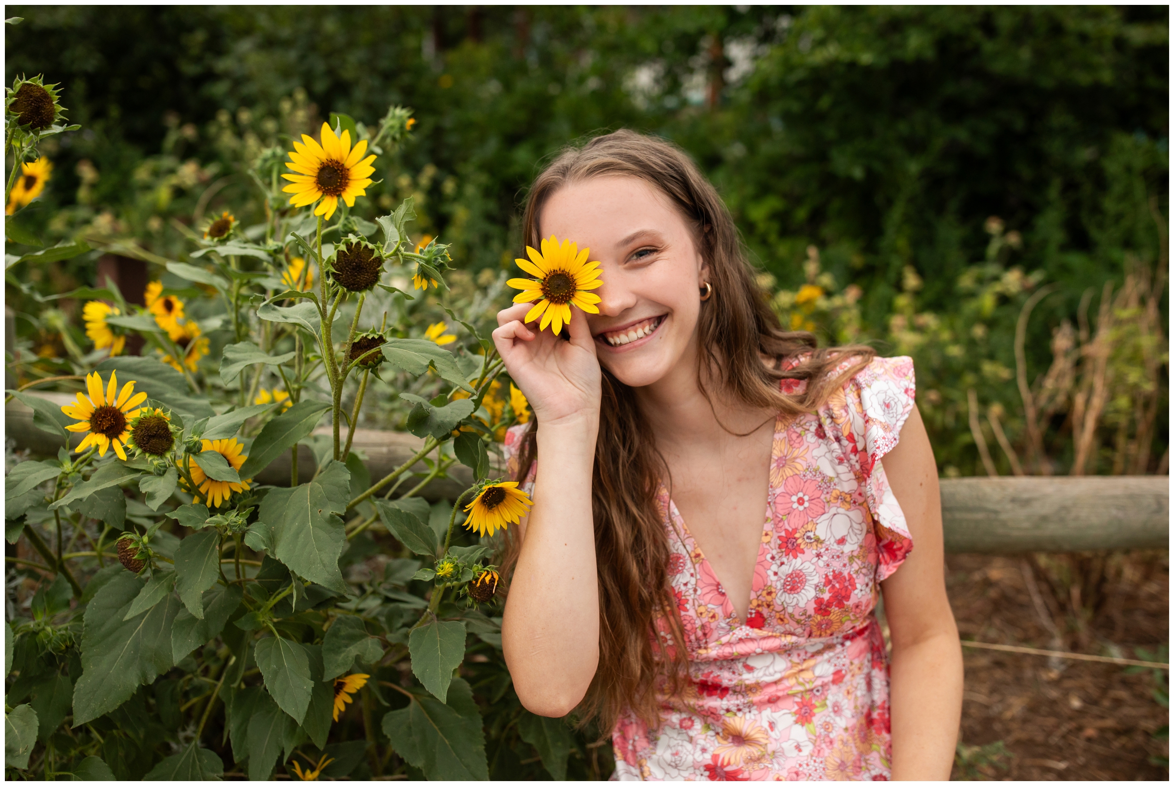 teen posing with sunflowers at Colorado portrait photography session 
