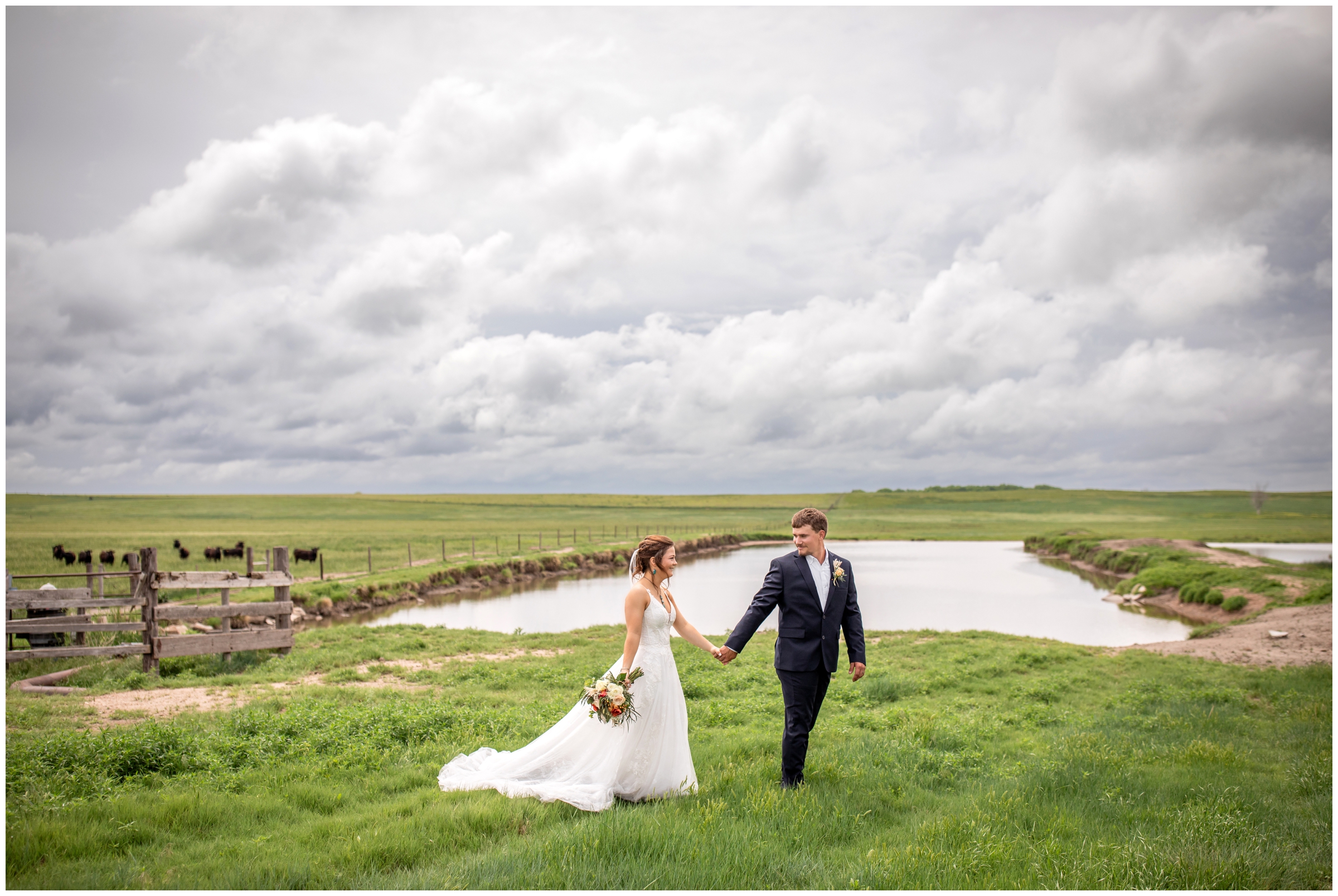couple walking through field at Colorado farm wedding in Crook