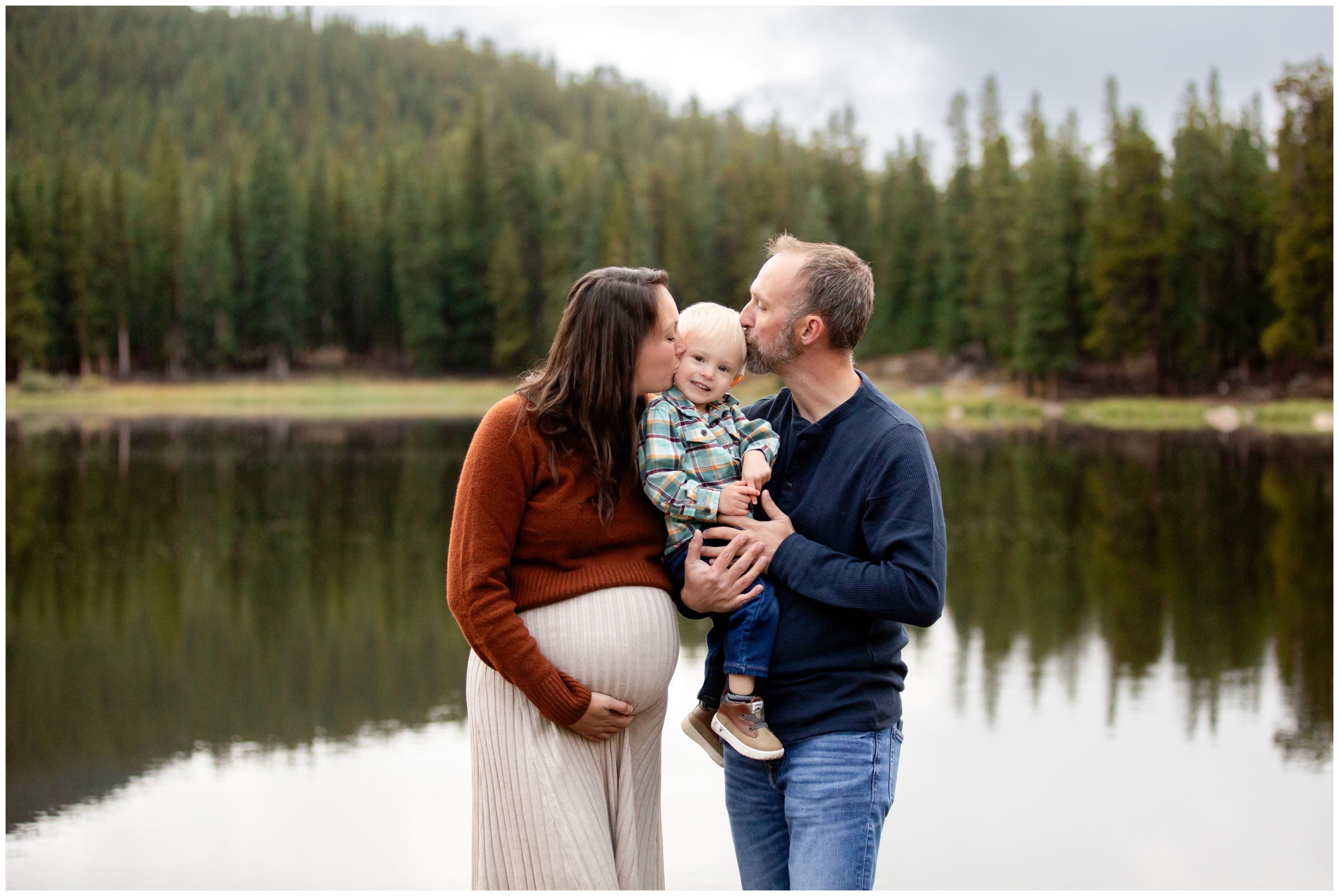 couple kissing their son next to Echo Lake during Colorado mountain maternity family photography session in Idaho Springs 