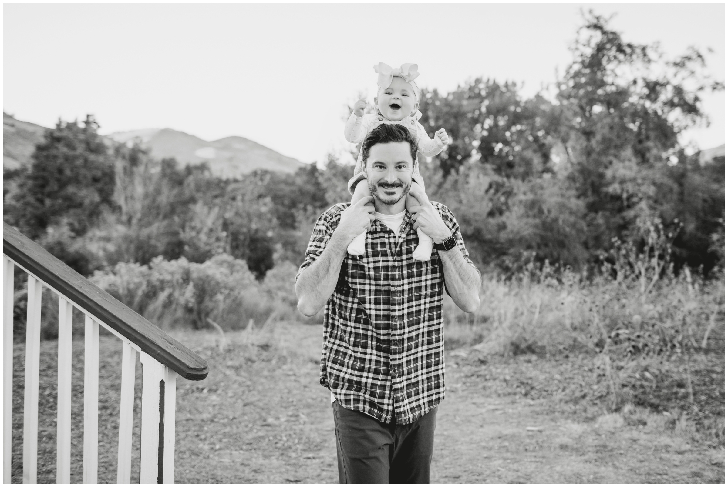 dad with daughter on his shoulders during candid family pictures in Golden Colorado 