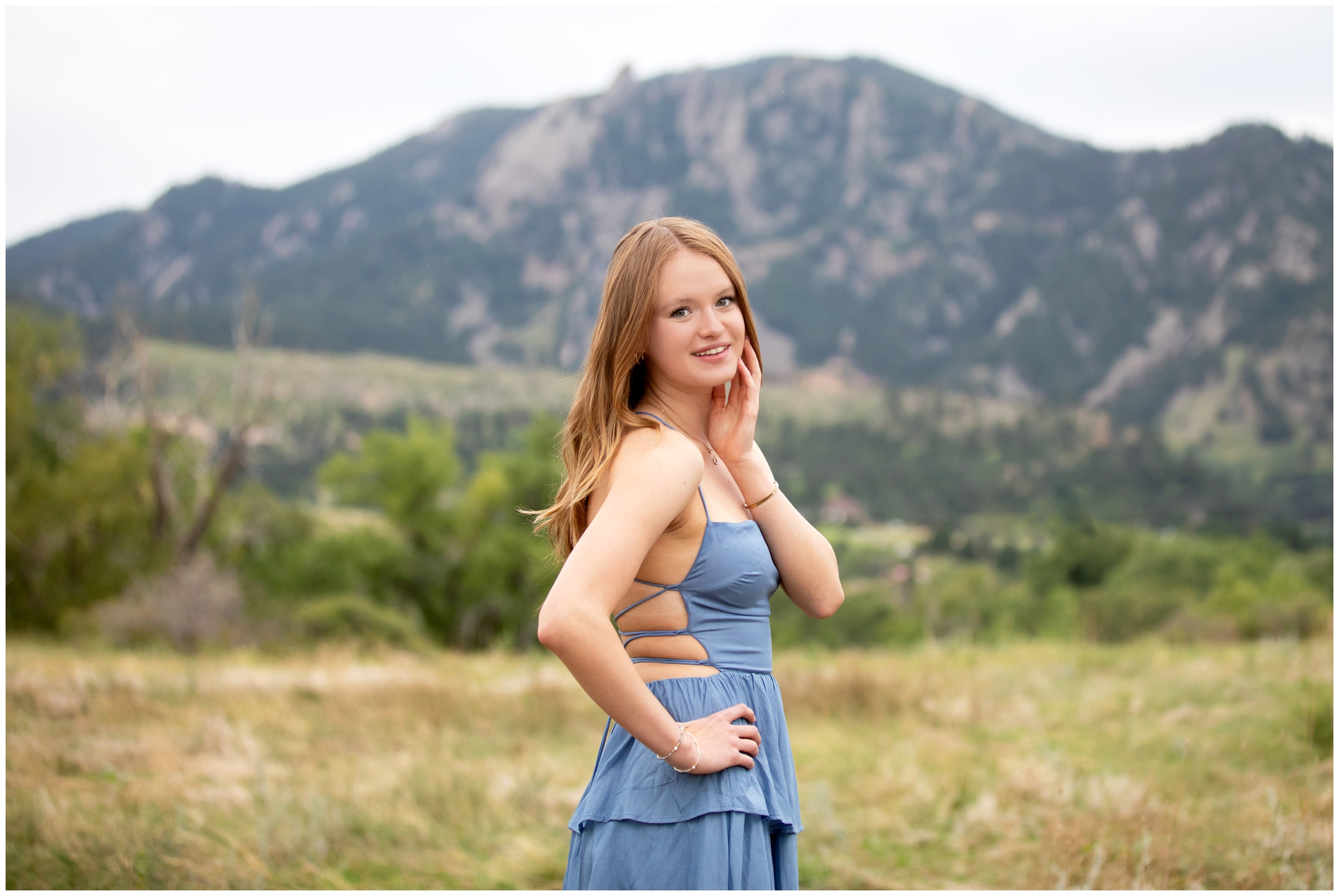 teen posing in mountain field during Prospect Ridge Academy senior photos at South Mesa Trail by Boulder Colorado portrait photographer Plum Pretty Photography