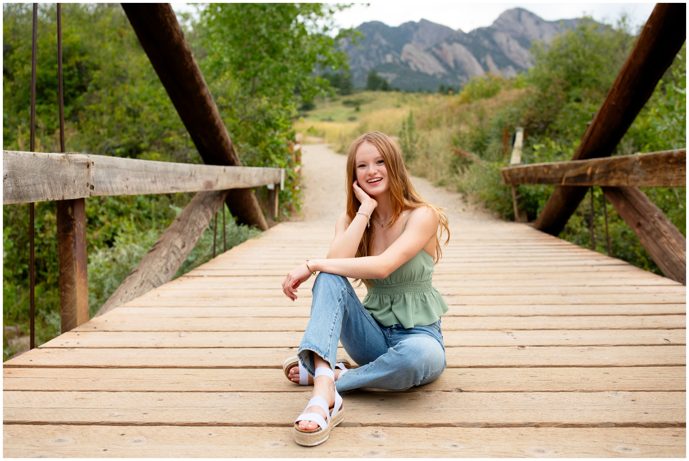 Prospect Ridge Academy Colorado high school senior posing on wooden bridge at South Mesa trail