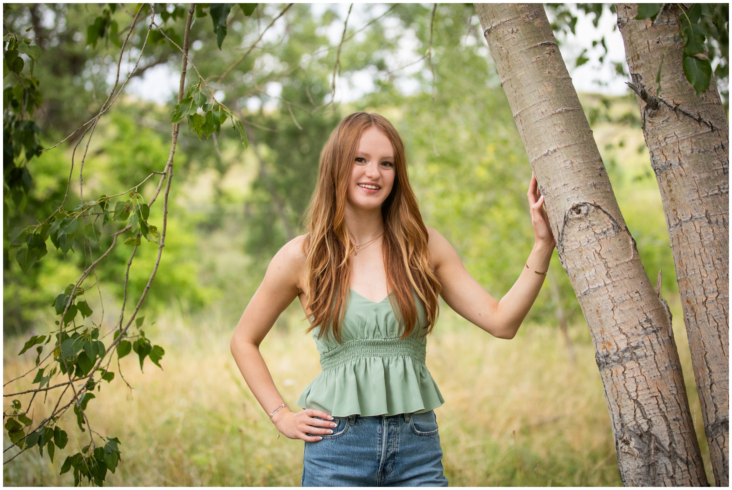 teen leaning against aspen tree during Boulder Colorado summer senior pictures 
