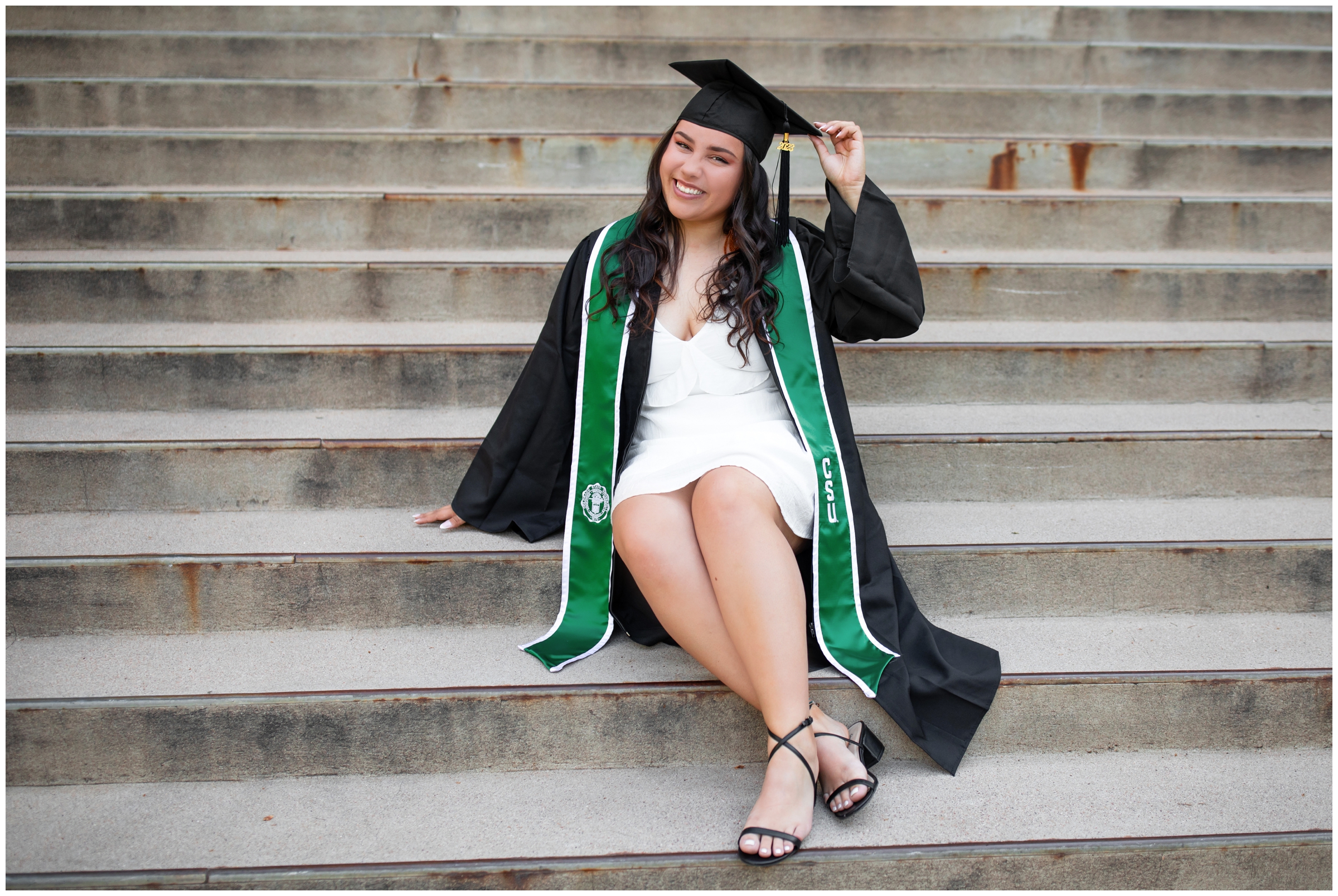 woman posing in cap and gown during CSU Fort Collins graduation senior portraits 