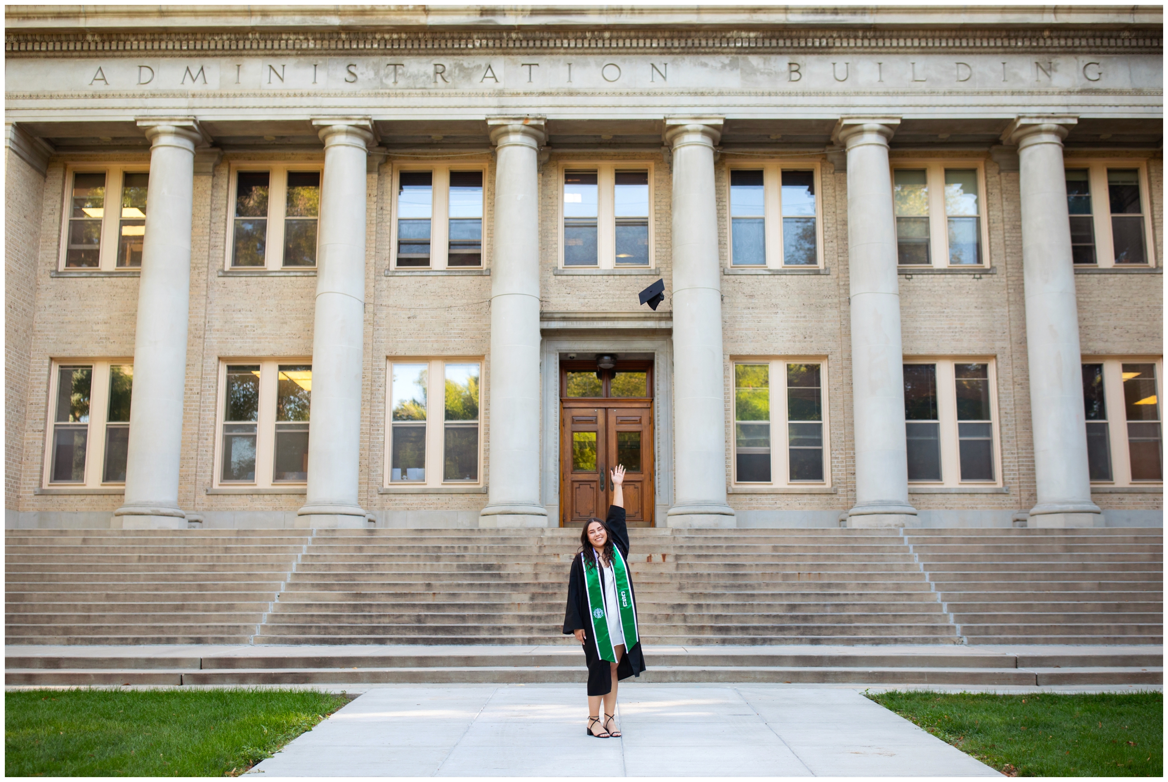 woman throwing graduation cap in the air during college senior pictures at Colorado State University 