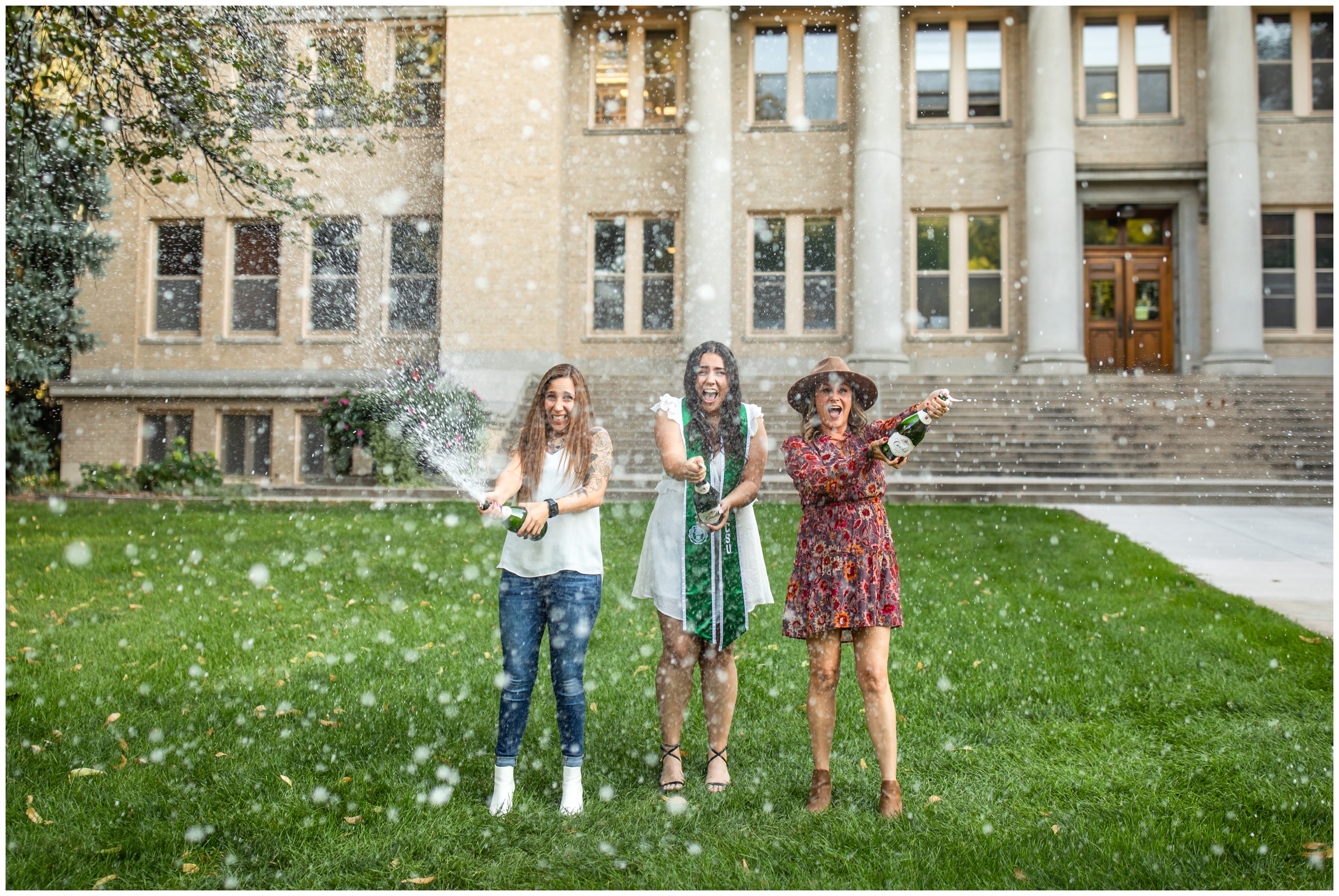 woman and her family popping champagne during Colorado college graduation photography session 