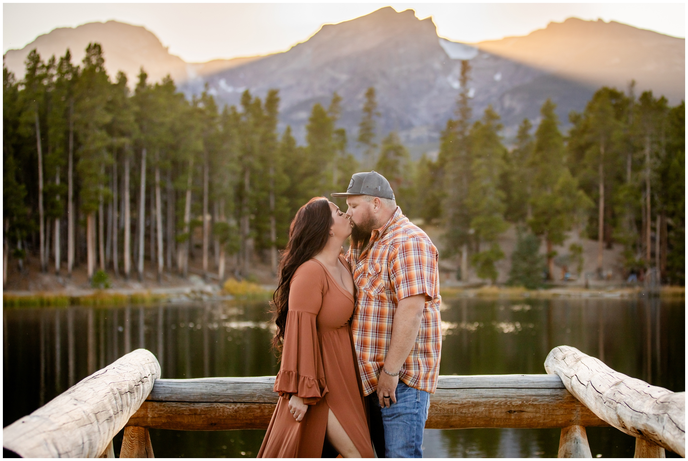 couple kidding on wooden dock during Estes Park couples portraits at Sprague Lake 
