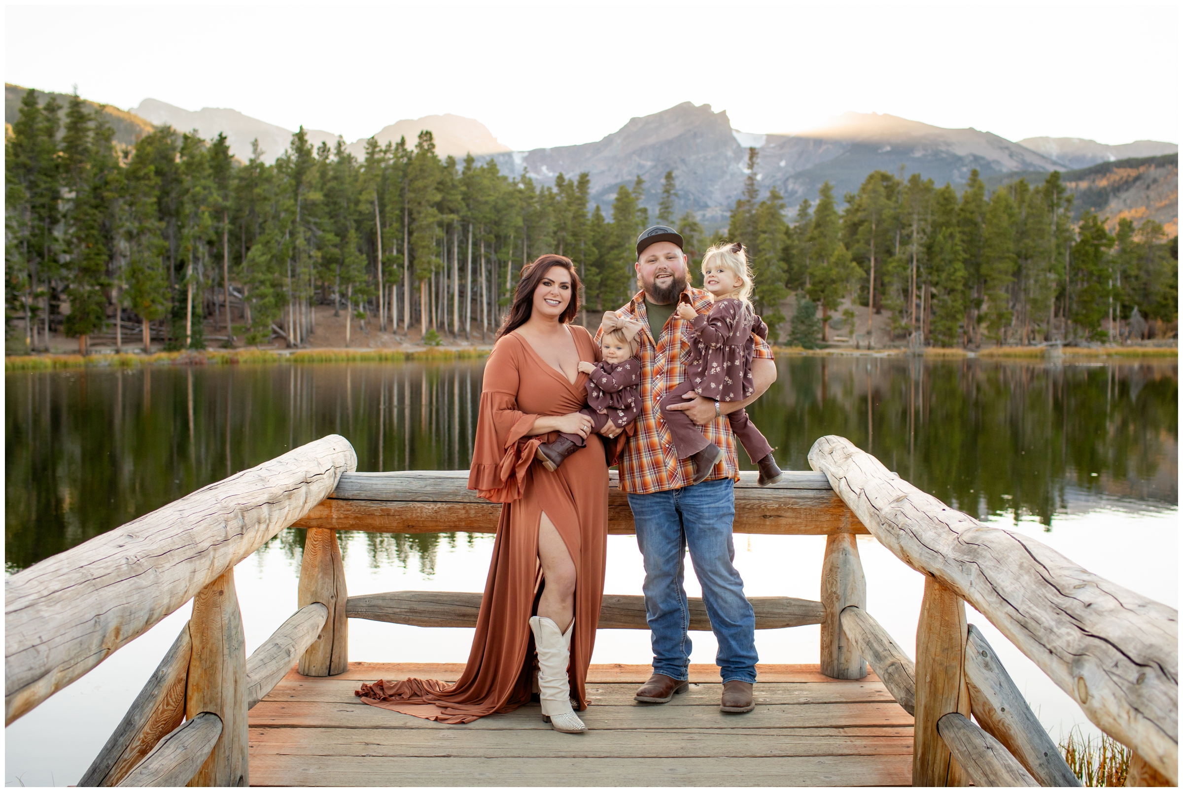 family posing on wooden dock at Sprague Lake during RMNP family portraits by Plum pretty Photography 