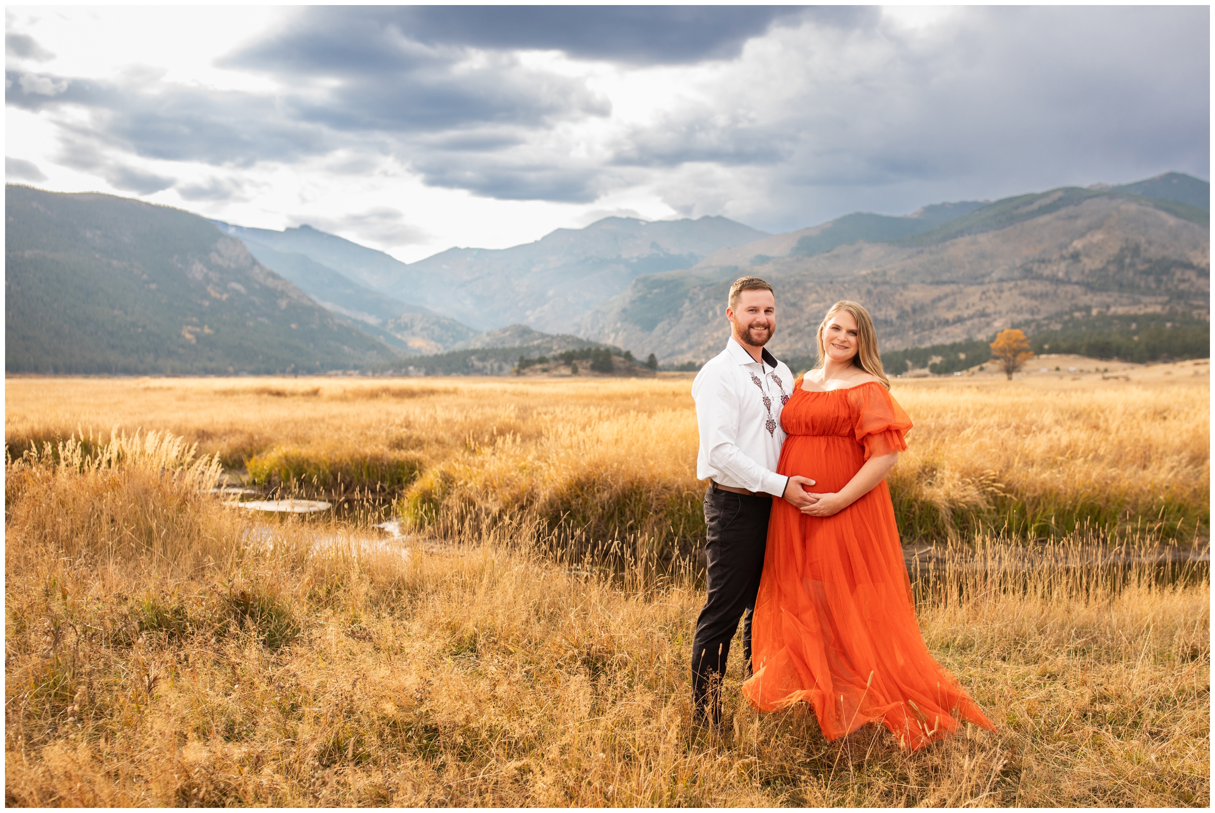 couple posing in mountain field at Moraine Park during Fall RMNP maternity photography at Moraine Park by Colorado portrait photographer Plum Pretty Photography 