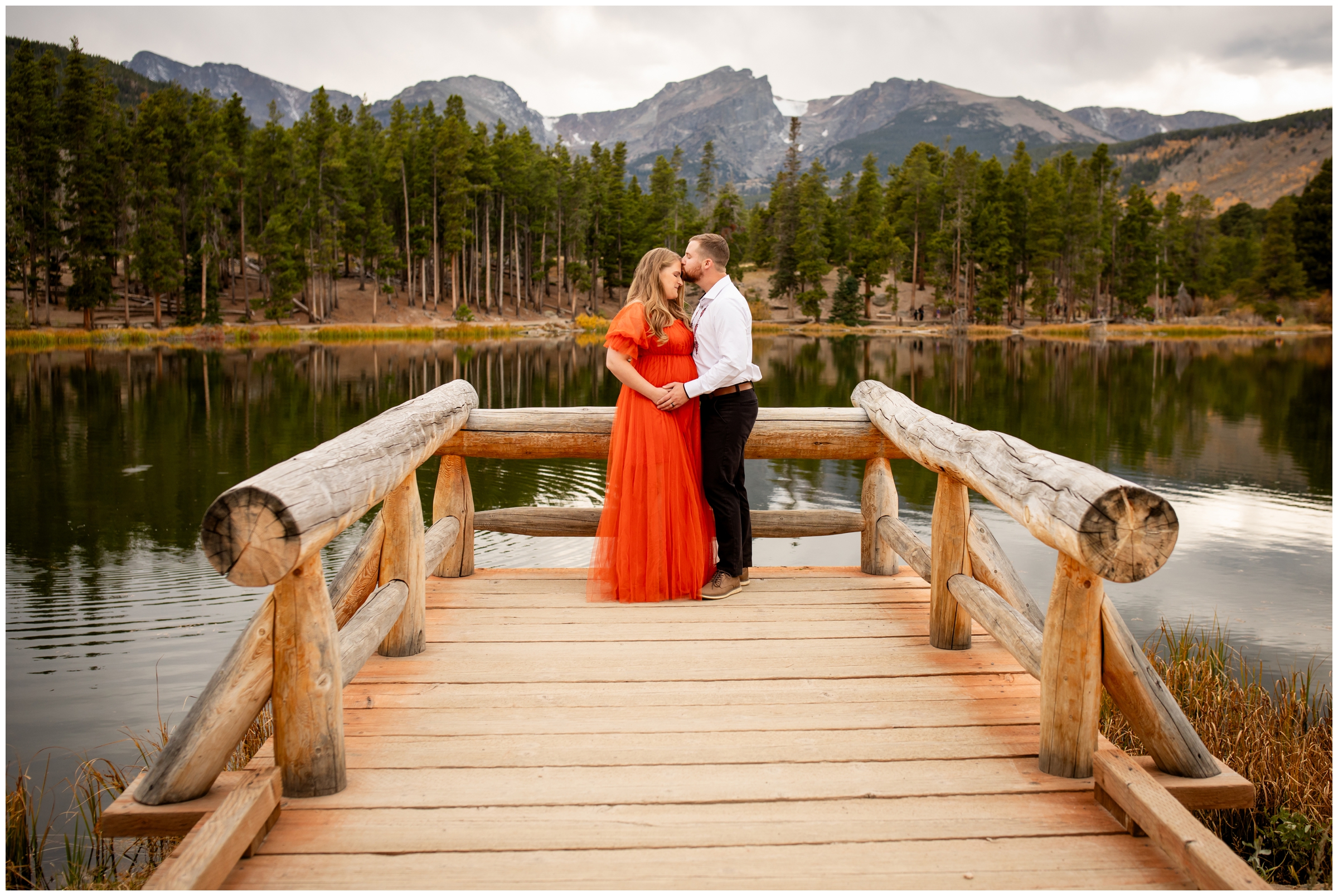 couple posing on dock during Estes Park Colorado maternity photos at Sprague Lake 