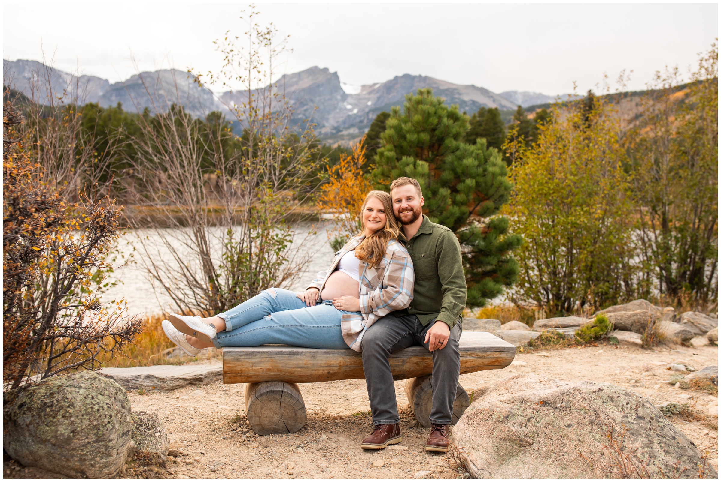 couple posing on wooden bench during Sprague Lake Colorado maternity photography session 