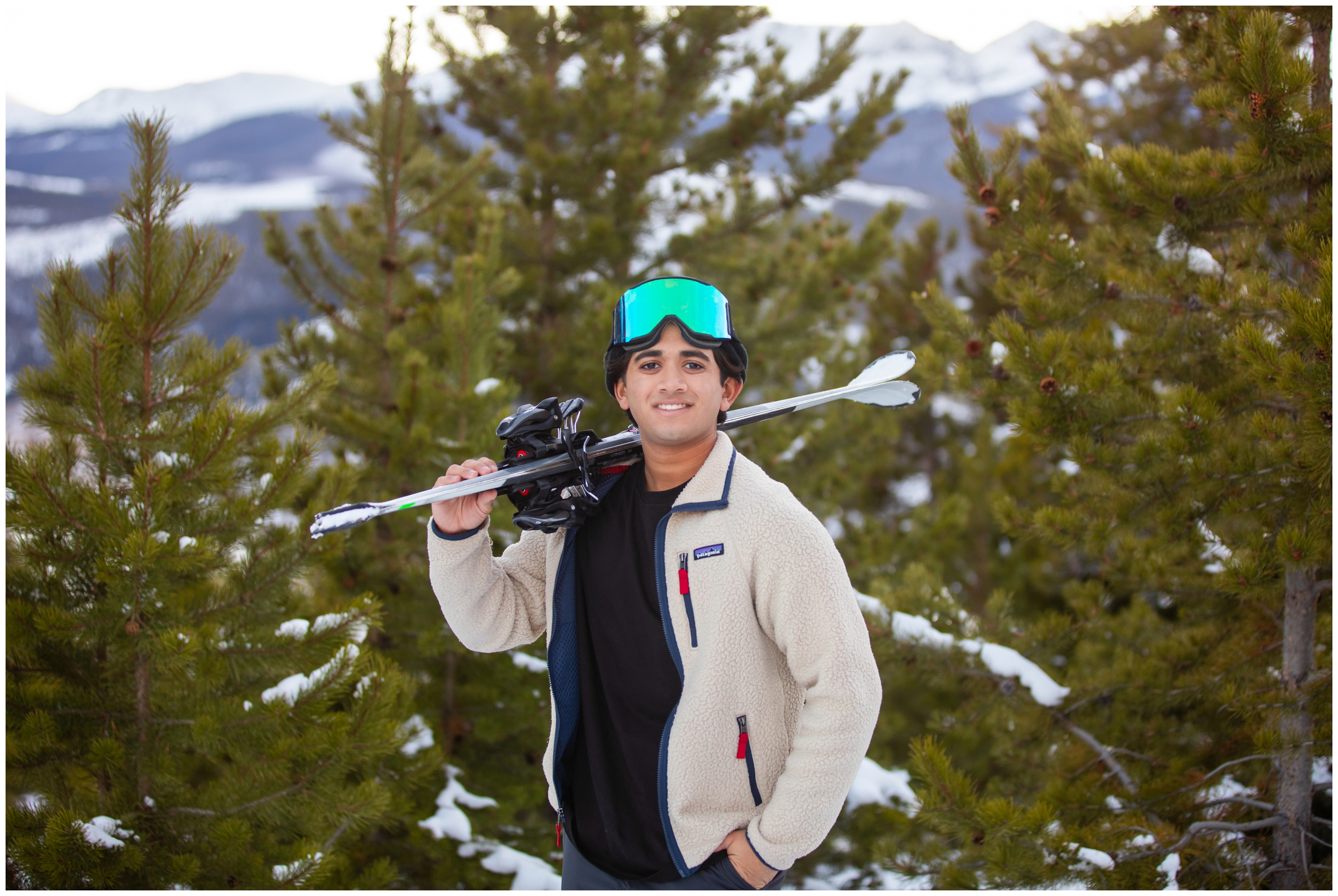teen posing with skis during portrait session at Sapphire Point in CO mountains