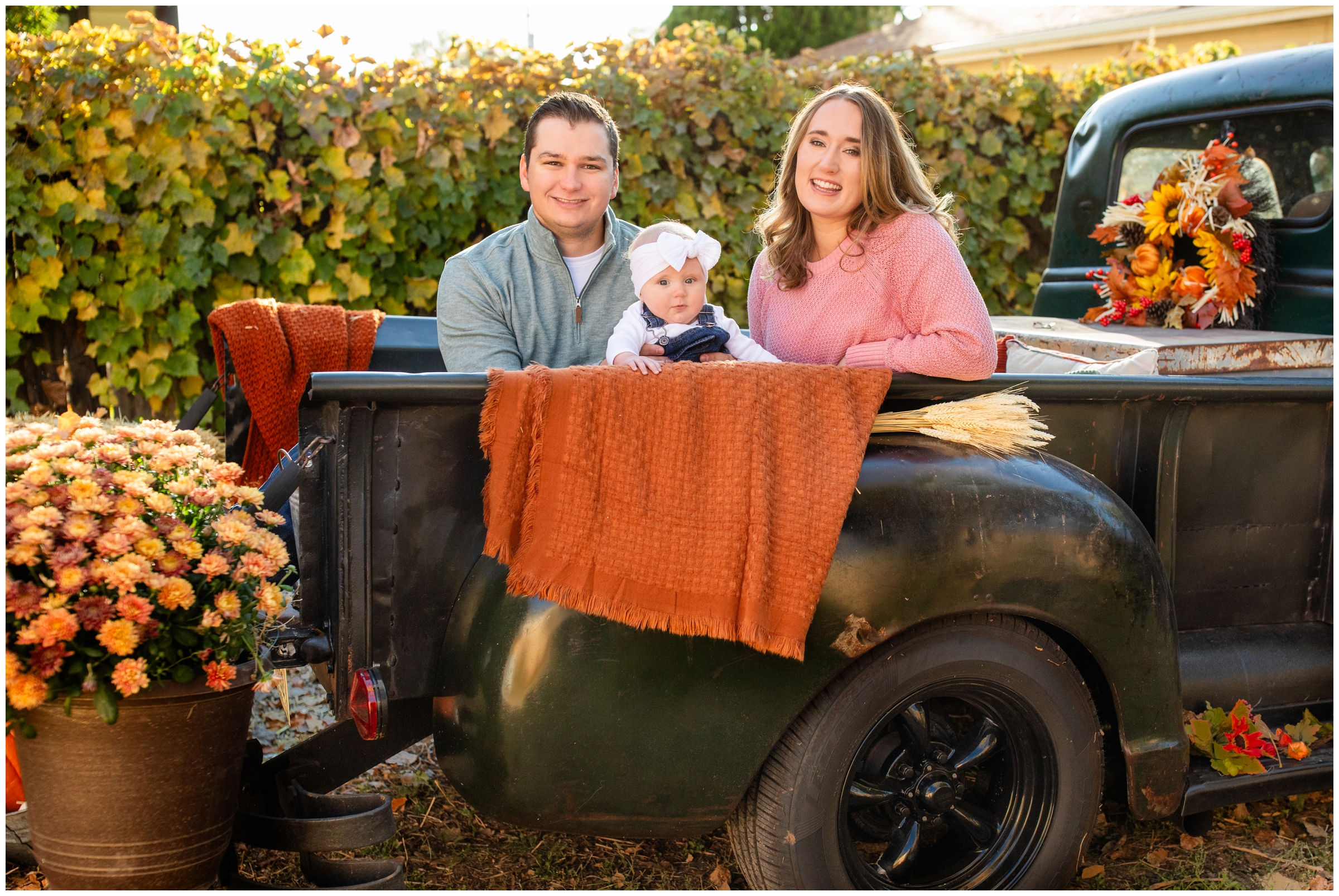 family posing in vintage truck during fall photography mini sessions by Plum Pretty Photography 
