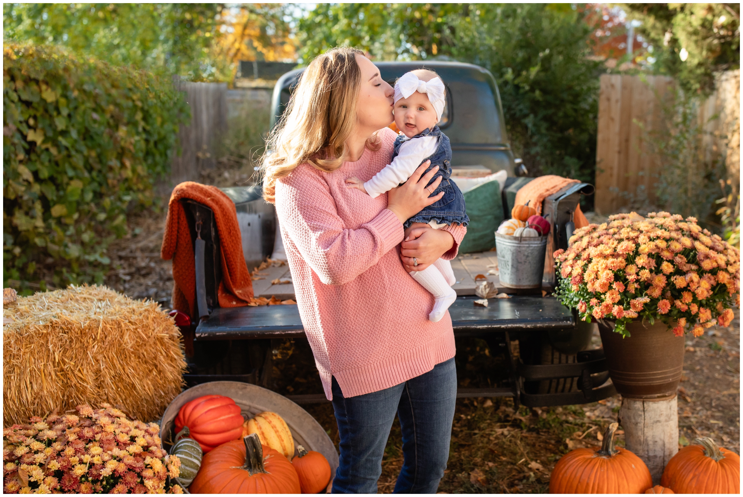 mom kissing baby daughter during fall family photography mini sessions by Frederick Colorado photographer Plum Pretty Photography 