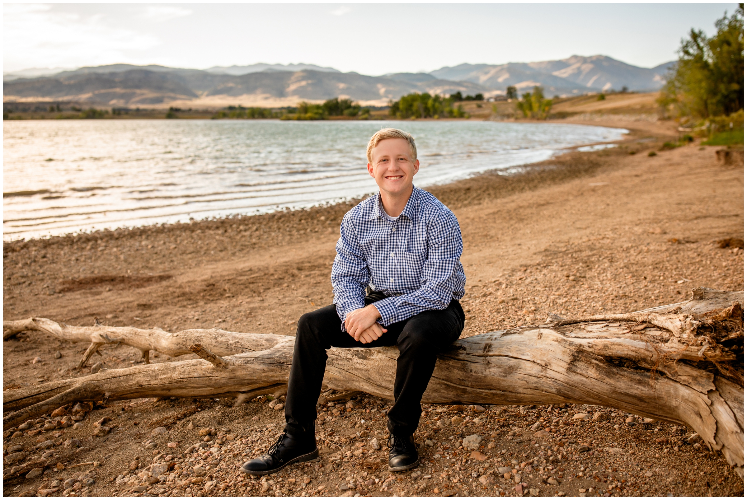 teen guy posing on wooden log during Coot Lake Colorado senior pictures by Plum Pretty Photography 