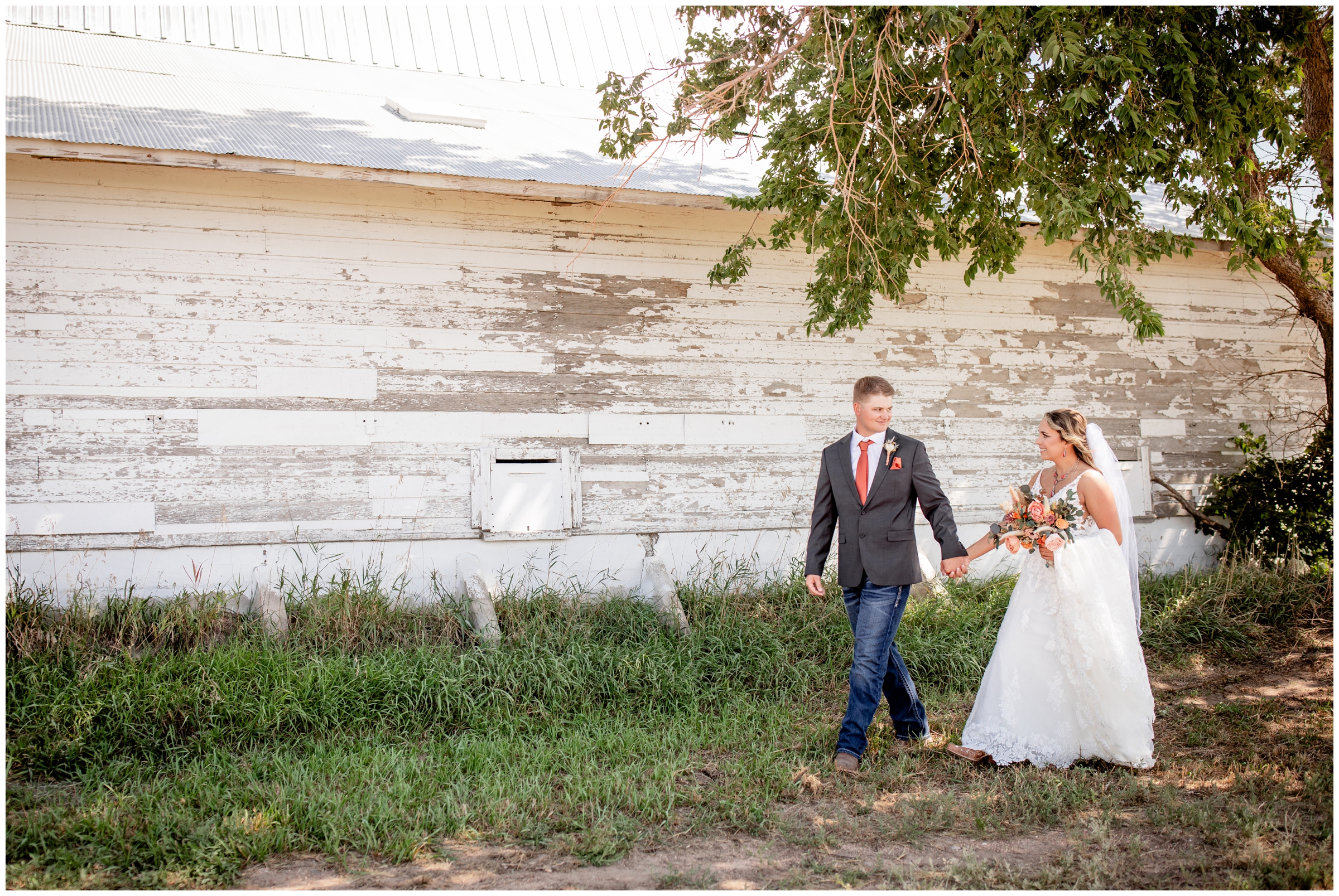candid wedding photos of a couple walking in front of a barn in Haxtun Colorado 