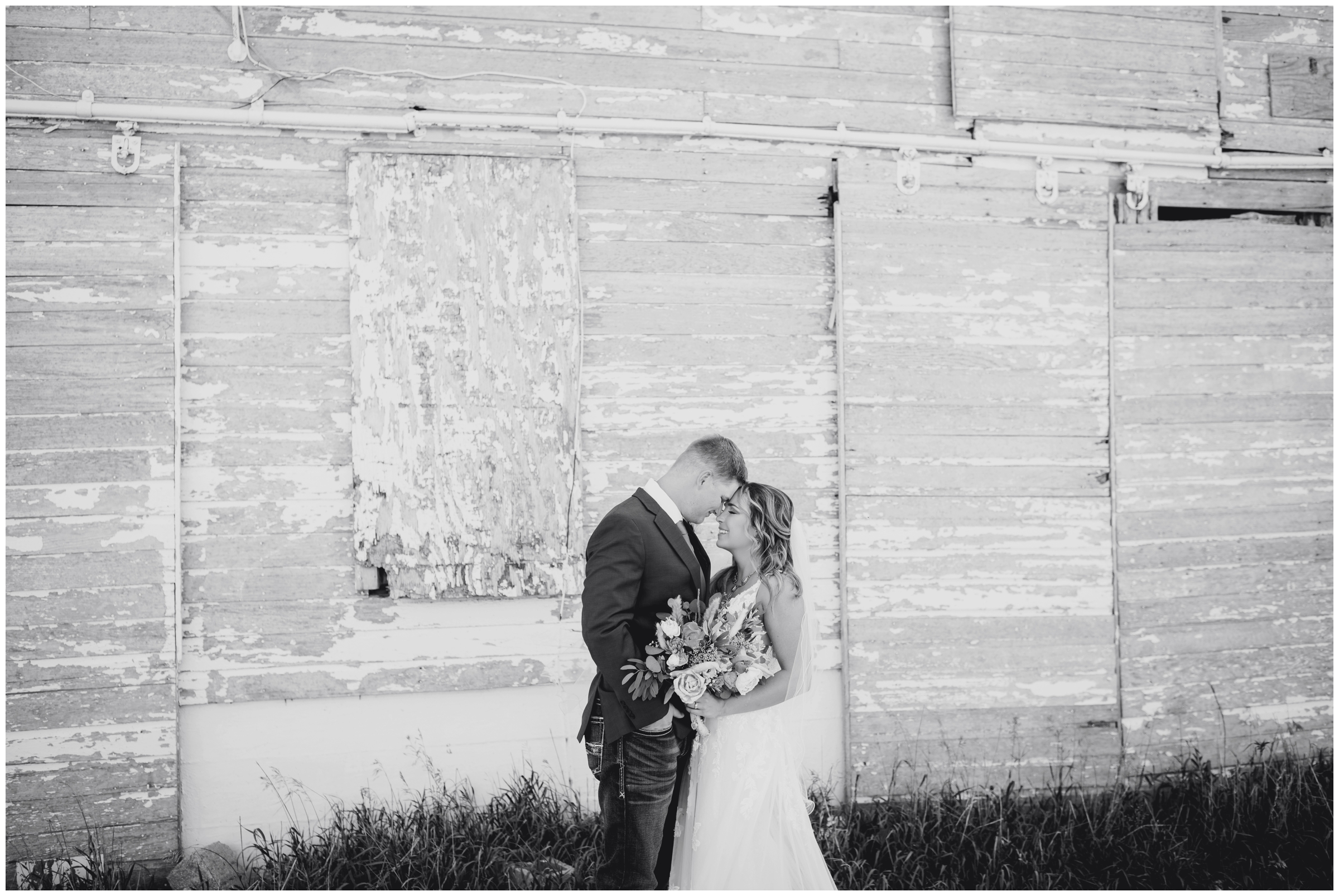 romantic wedding portraits in front of a barn during rustic Colorado wedding portraits in Haxtun 