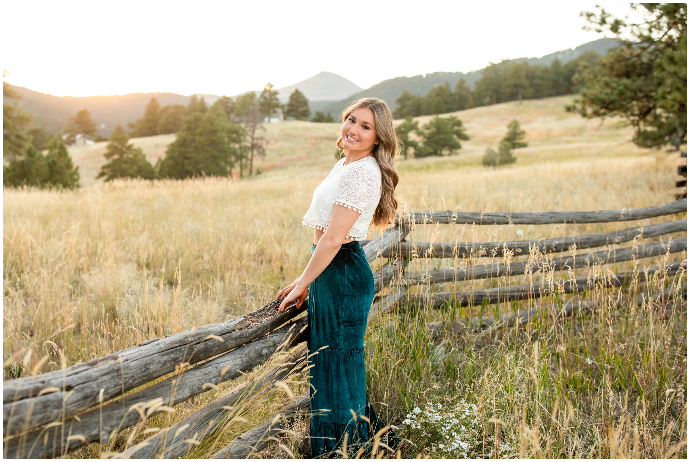 teen posing against wooden fence during Holy Family High School senior portraits in Boulder Colorado 