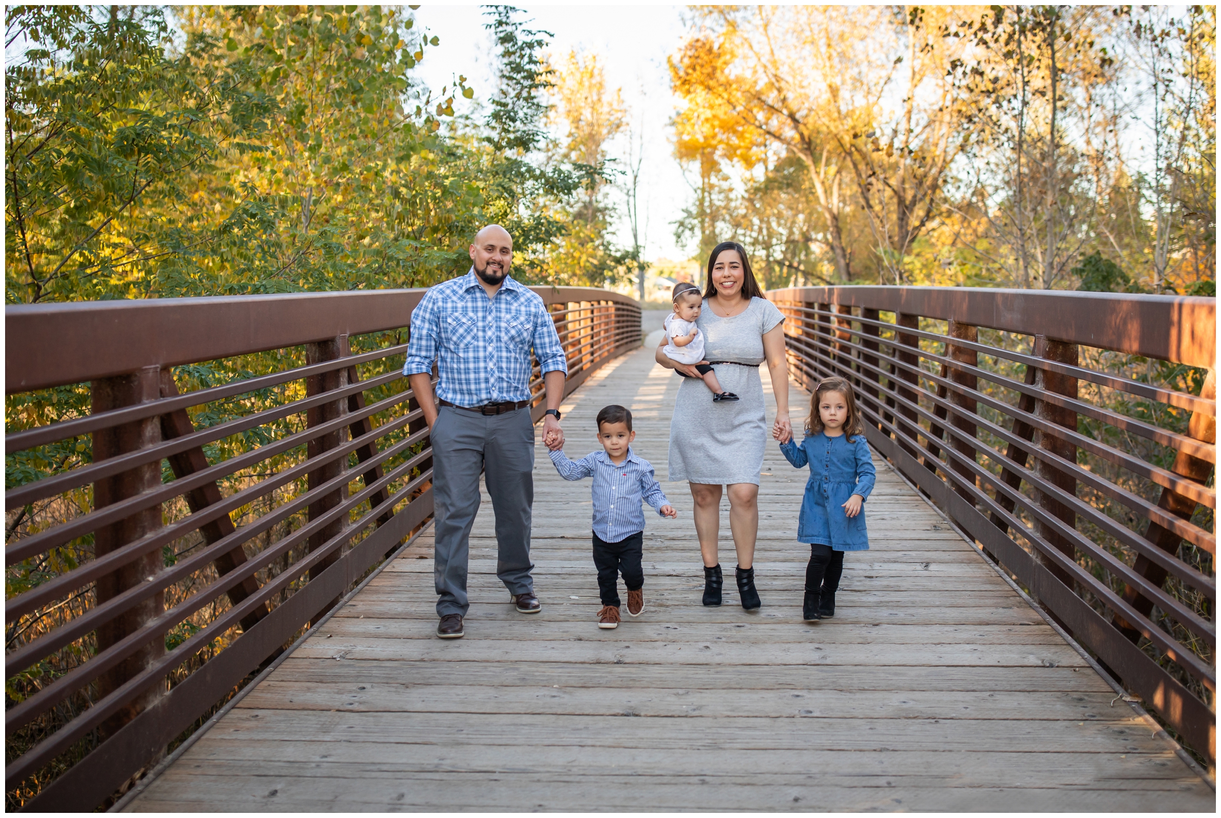 candid family pictures on a bridge in Longmont Colorado 