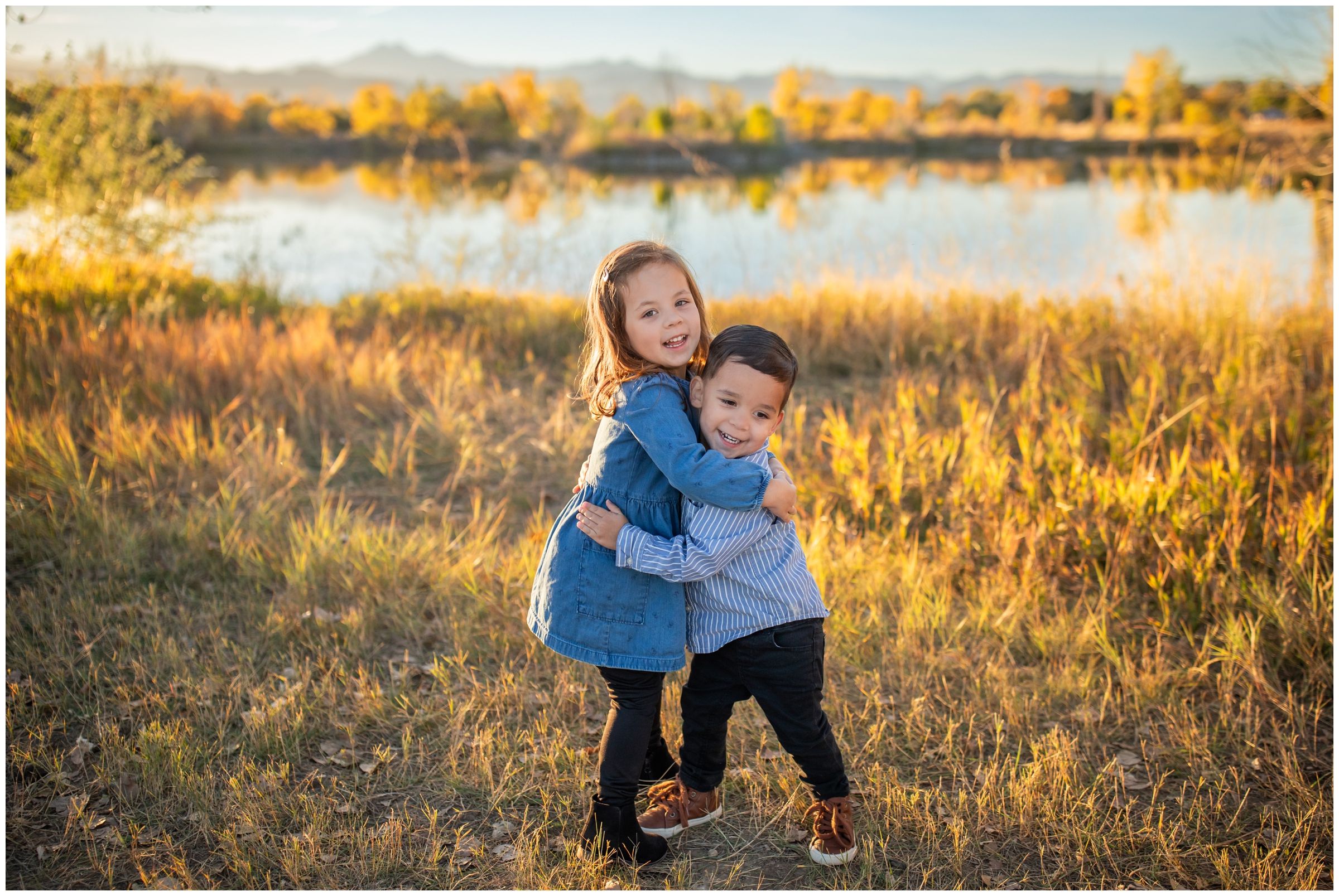 brother and sister hugging during candid family photos at Golden Ponds in Longmont Colorado 