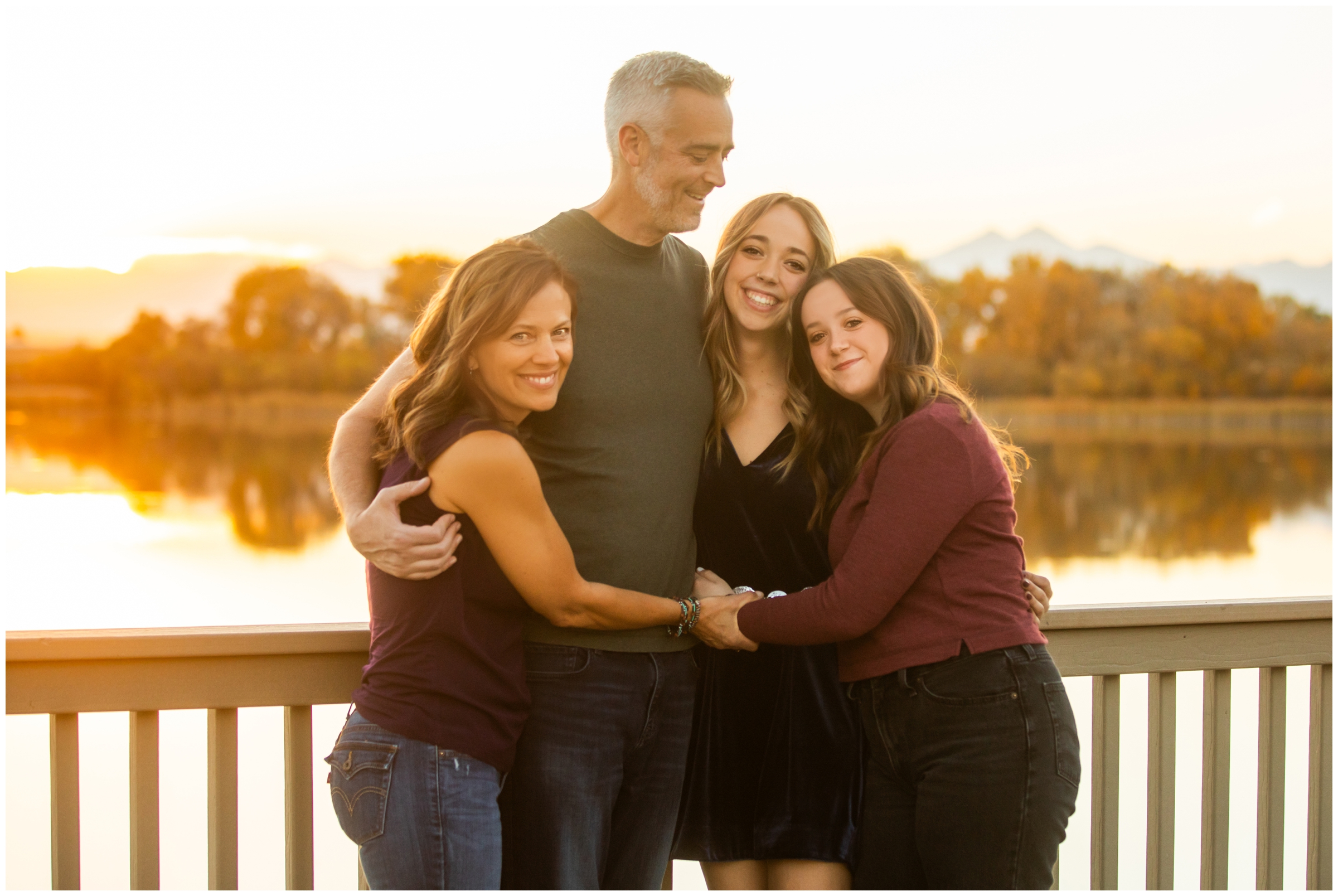 adult family hugging during Colorado lake photography session in Mead
