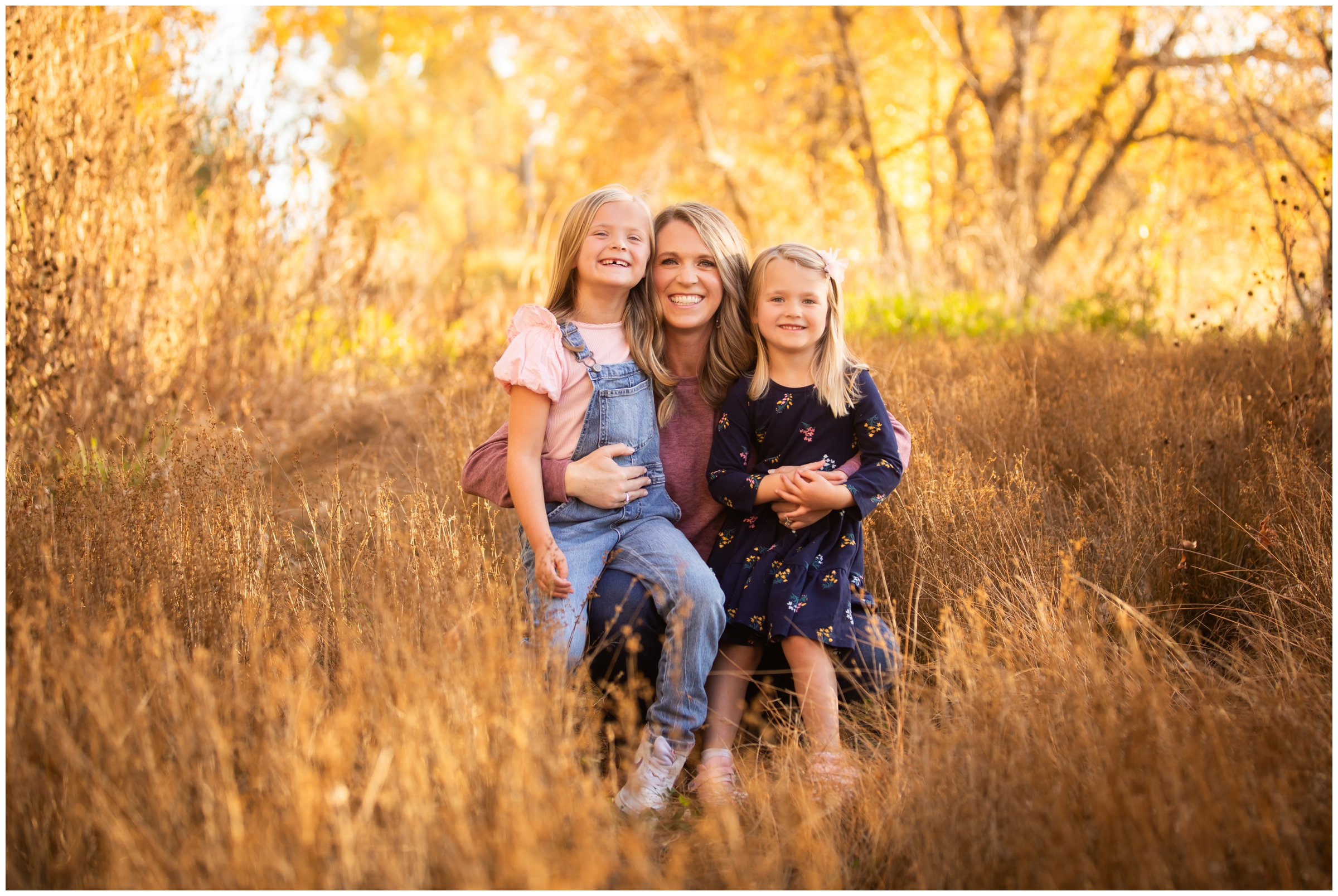 mom and daughters cuddling during fall photography mini session in Mead Colorado 