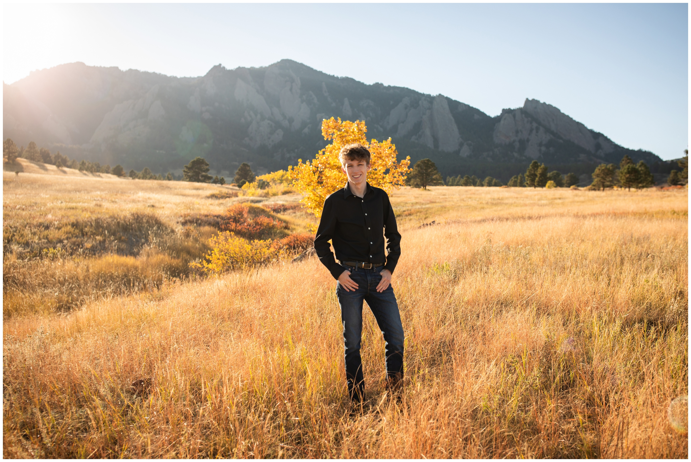 teen posing in front of Boulder flatirons during fall portrait session at Table Mesa Trail