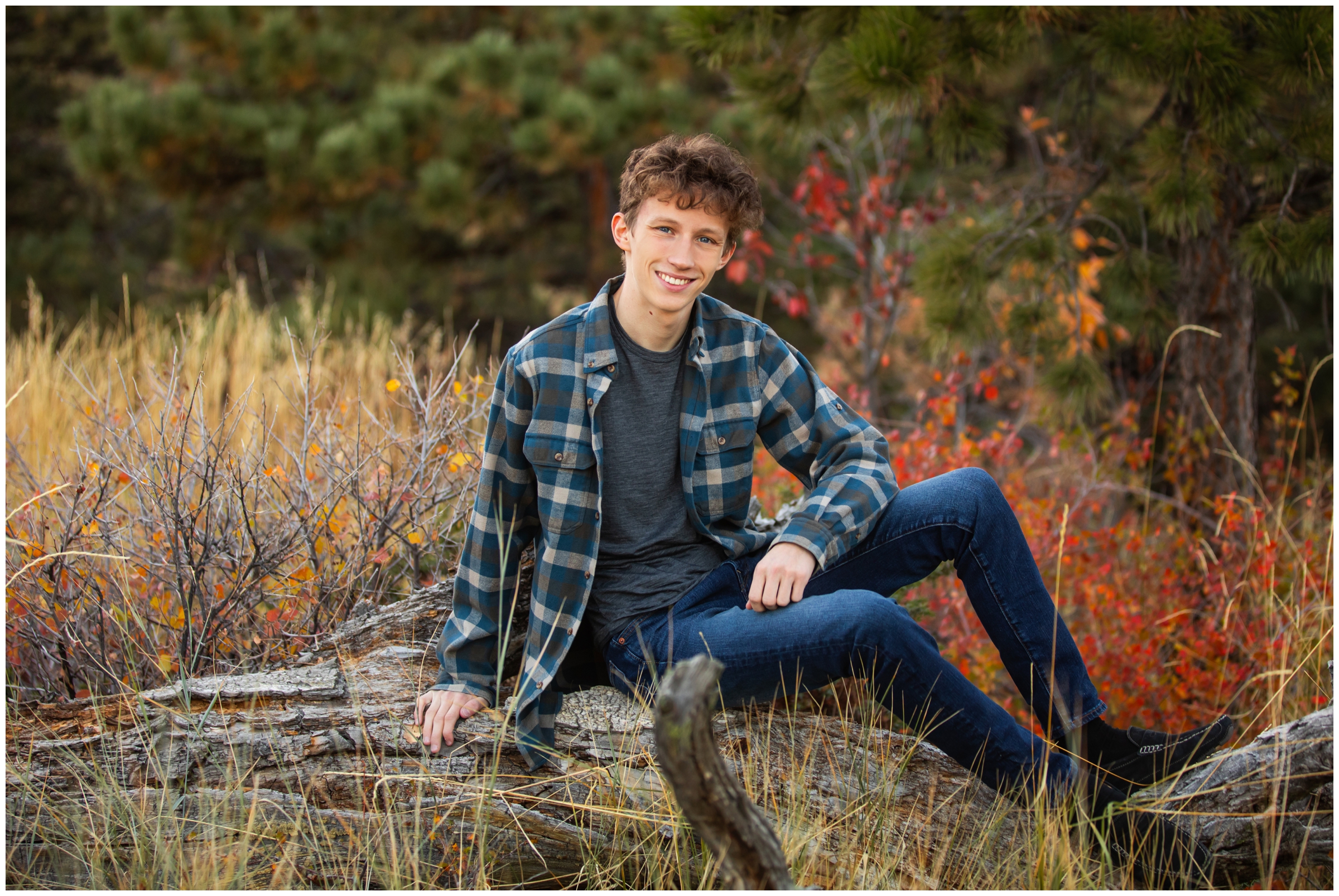 teen sitting on a tree stump during fall senior photography session in Boulder Colorado 