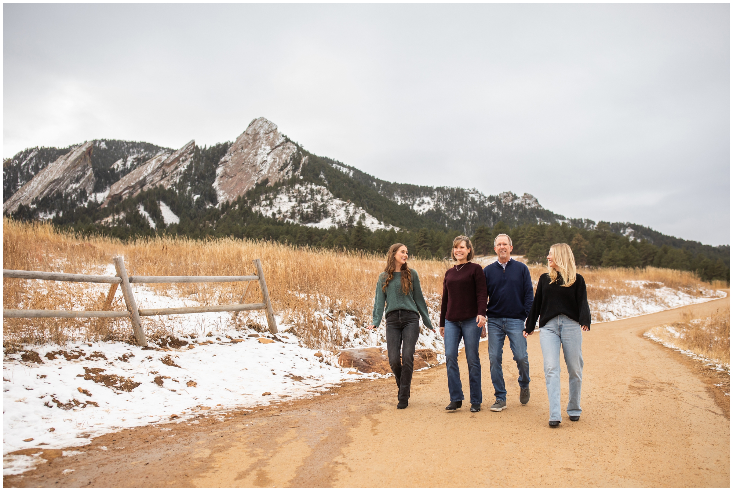 candid family photos of adults walking on trail at Chautauqua during winter family photography session in Boulder Colorado 