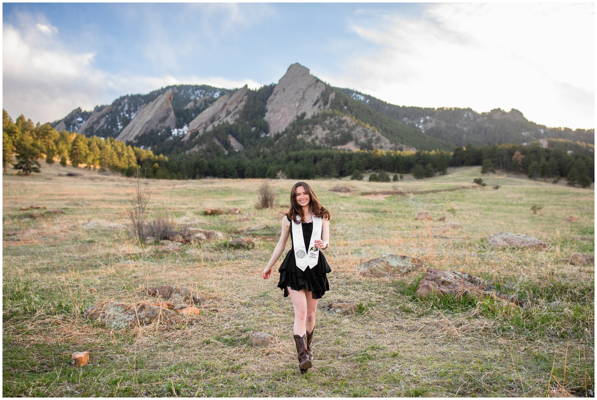 woman walking through a field during photography session at Chautauqua Park in colorado 