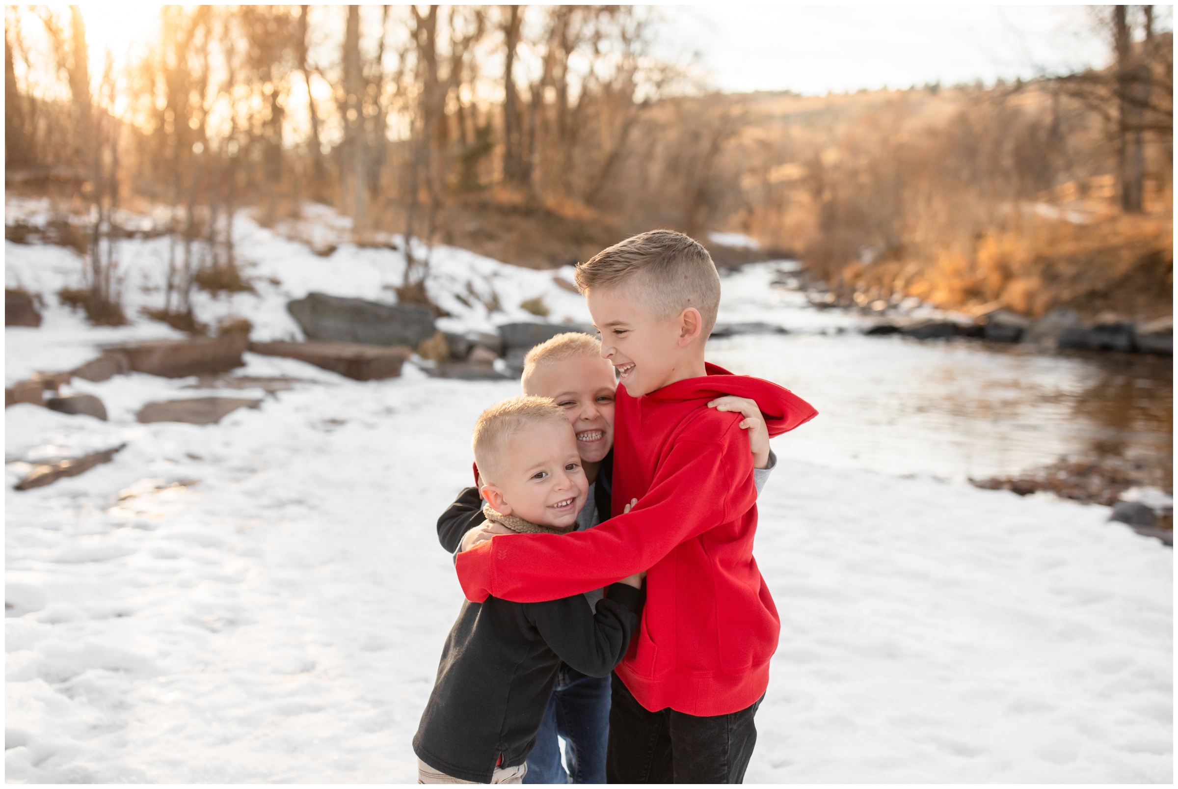brothers hugging during candid photos at Bohn Park during Lyons Colorado winter family photos 