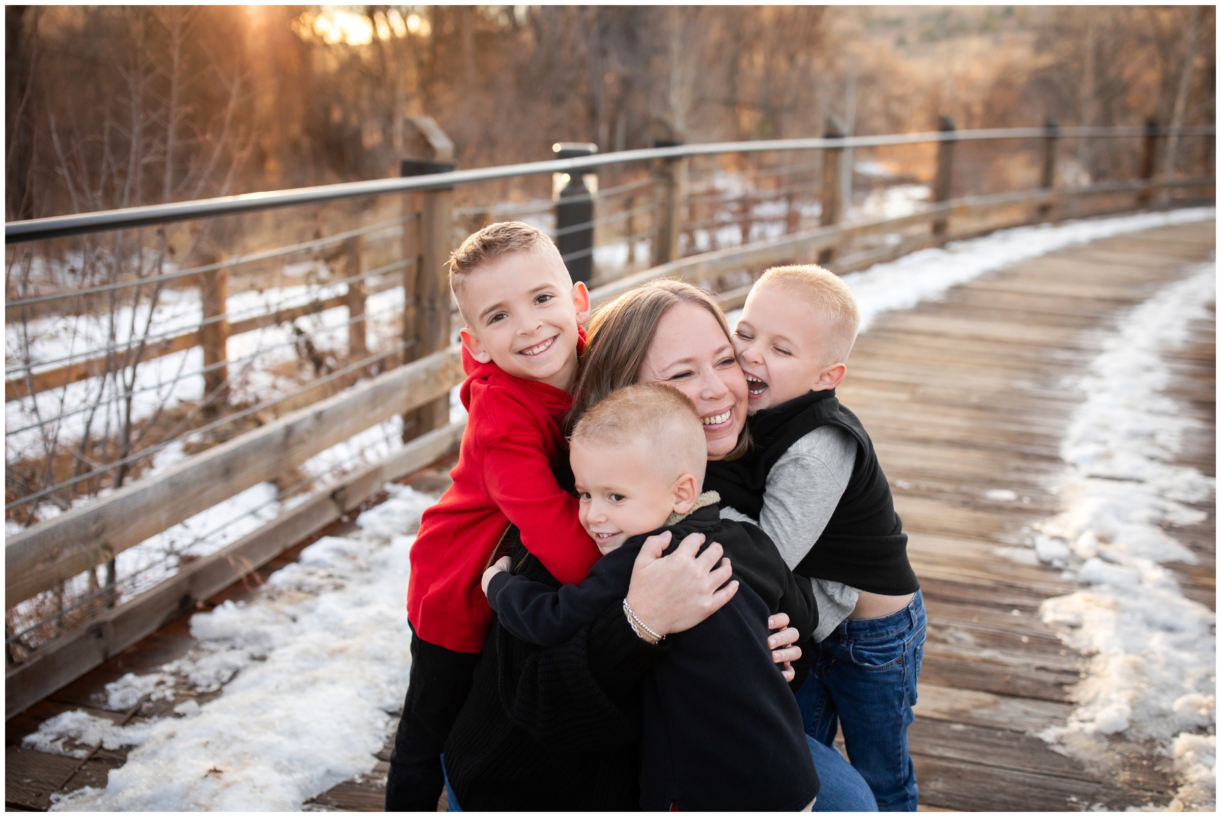 mom hugging her kids during winter family photos at Bohn Park in Lyons Colorado 