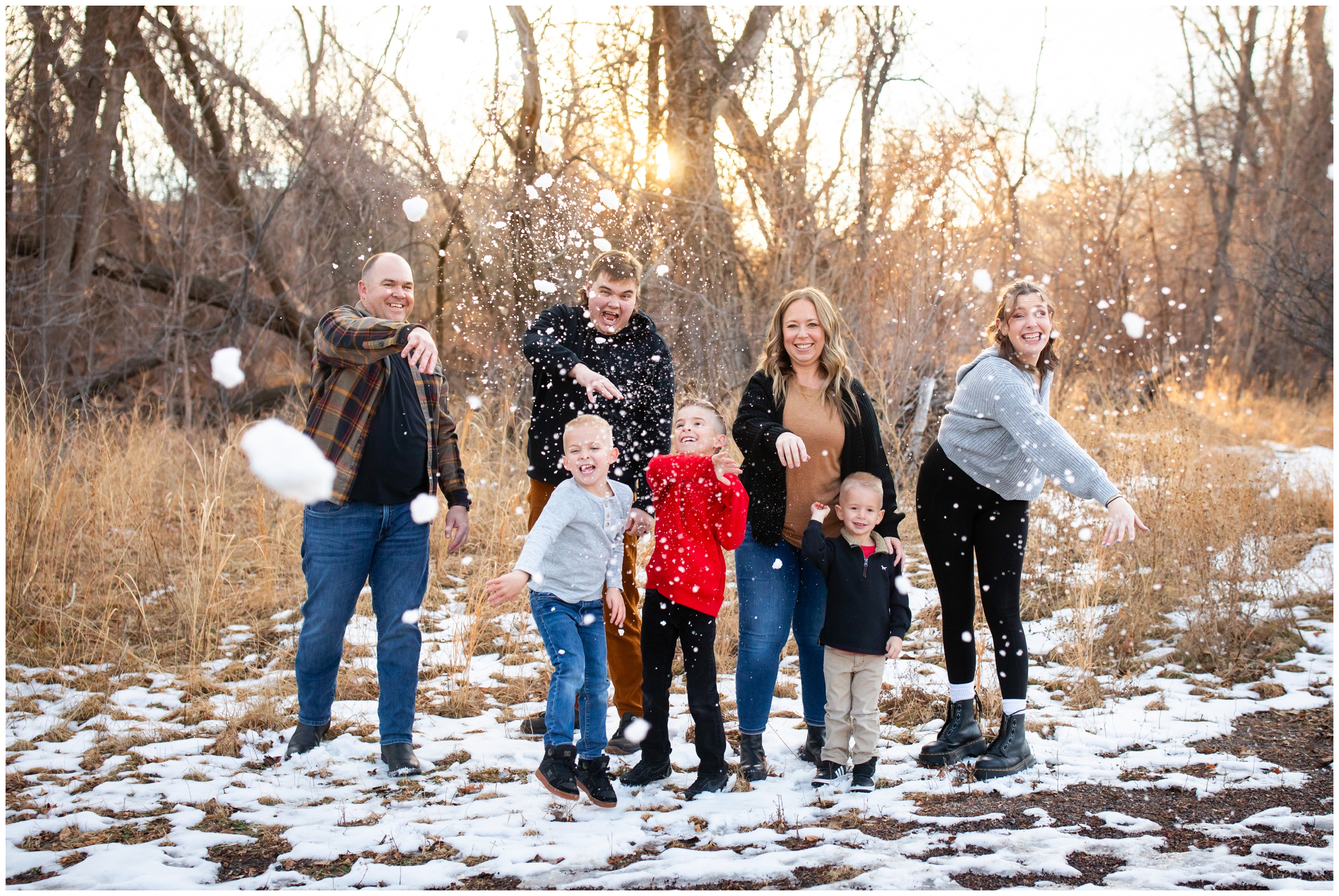 family throwing snowballs during candid winter family pictures in Lyons Colorado 