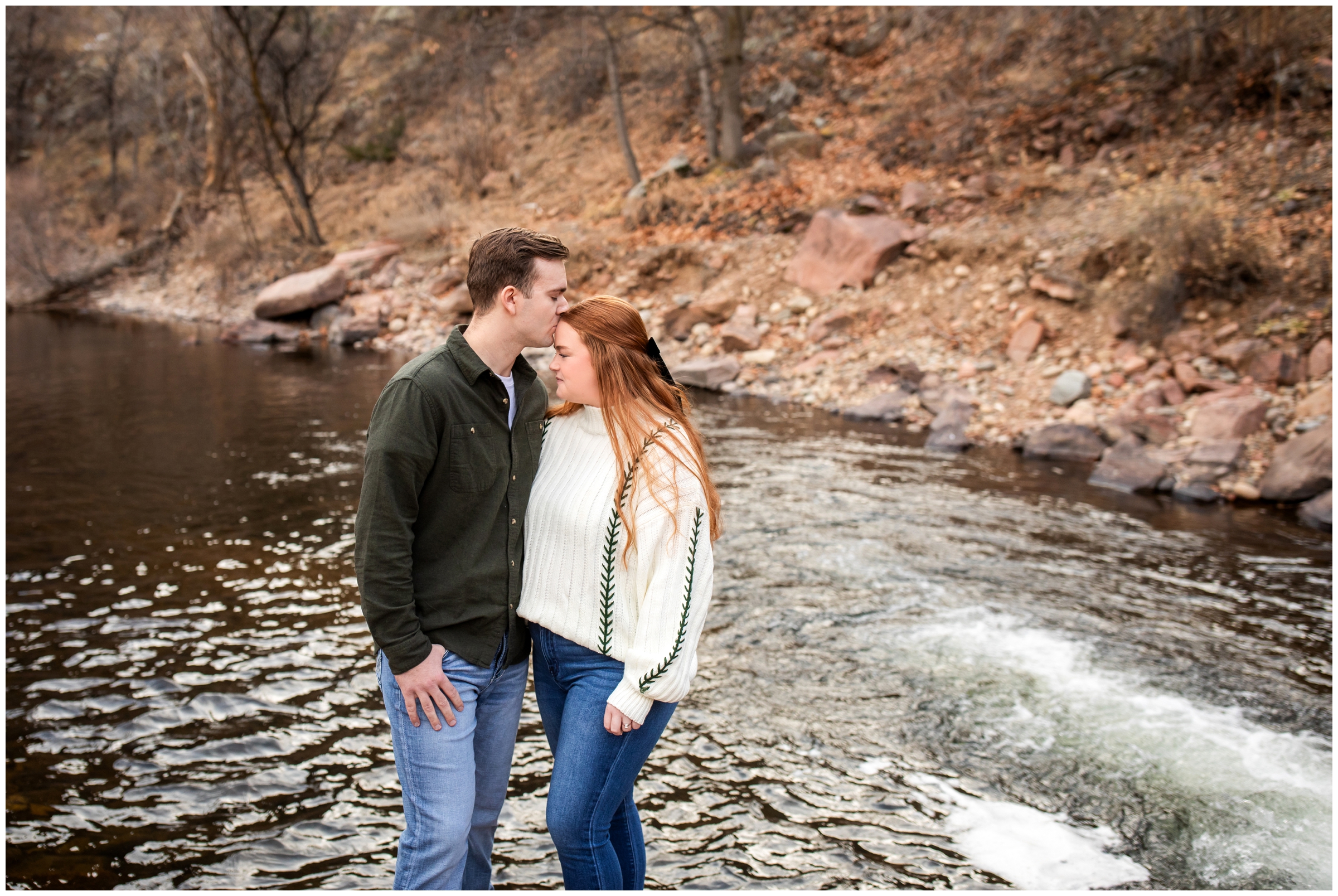 couple embracing near the river at Lavern Johnson Park during Lyons Colorado winter engagement pictures 