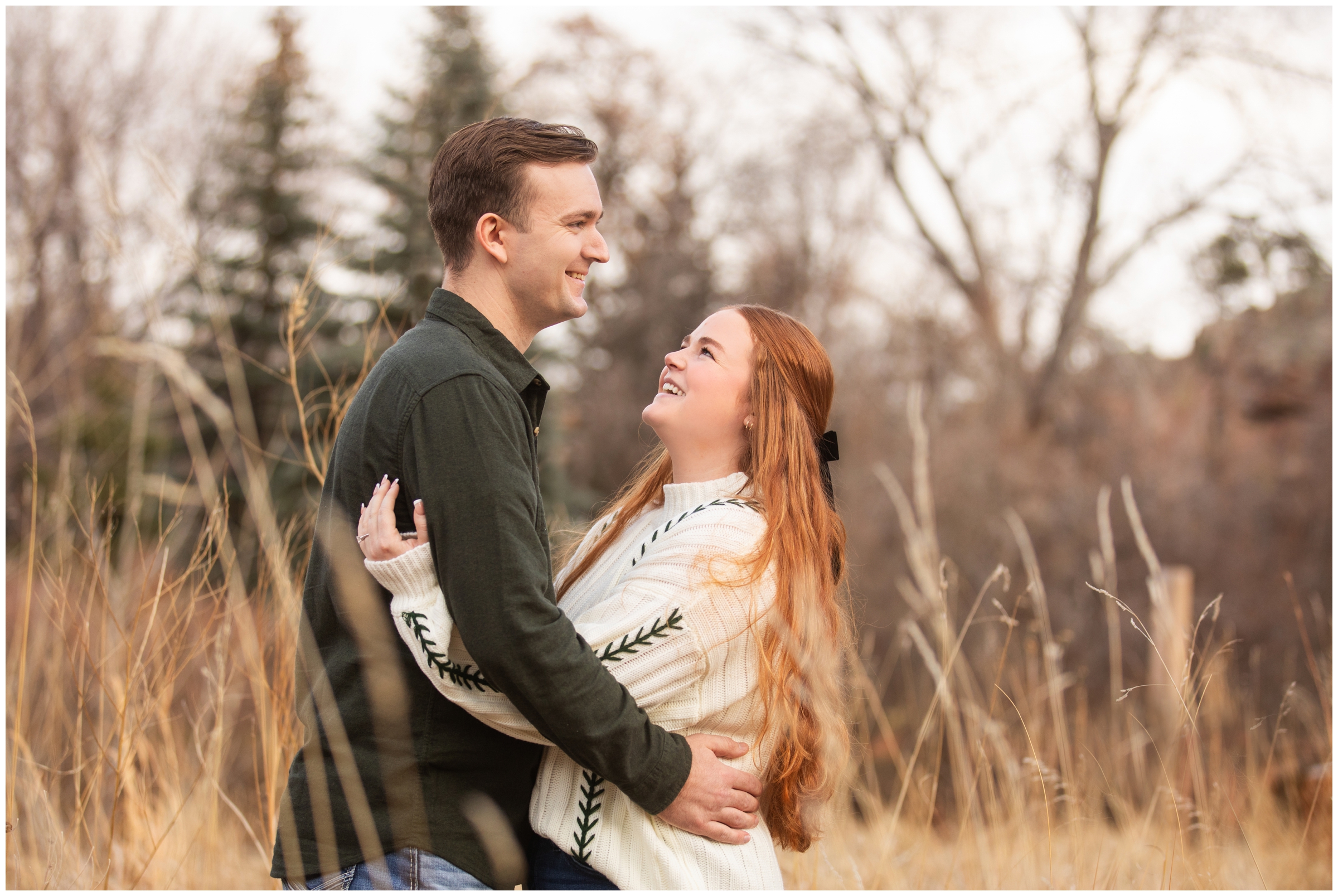 couple posing in a open field during winter engagement pictures in Lyons, Colorado