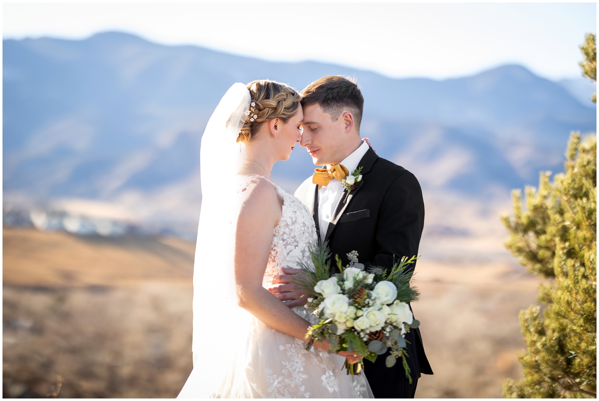 couple embracing with mountains in background during Colorado Springs wedding photos at The Pinery at the Hill