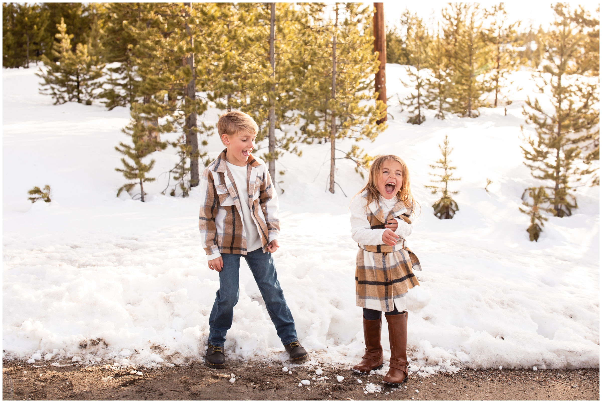 kids laughing after throwing snow during candid family pictures in Winter Park Colorado