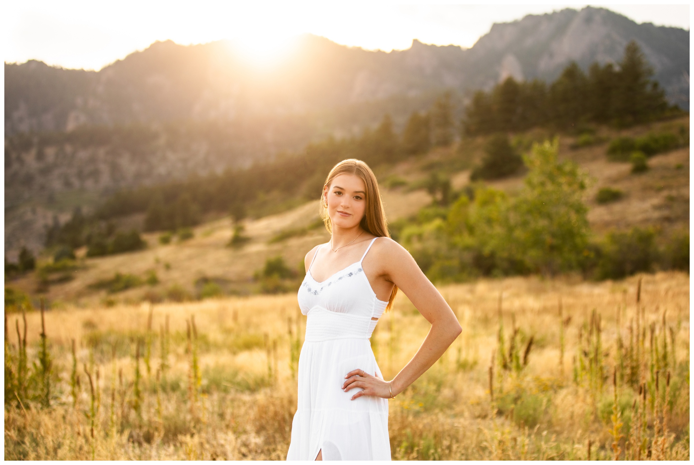 teen posing in mountain field of long grasses during Boulder Colorado senior photos at South Mesa Trail