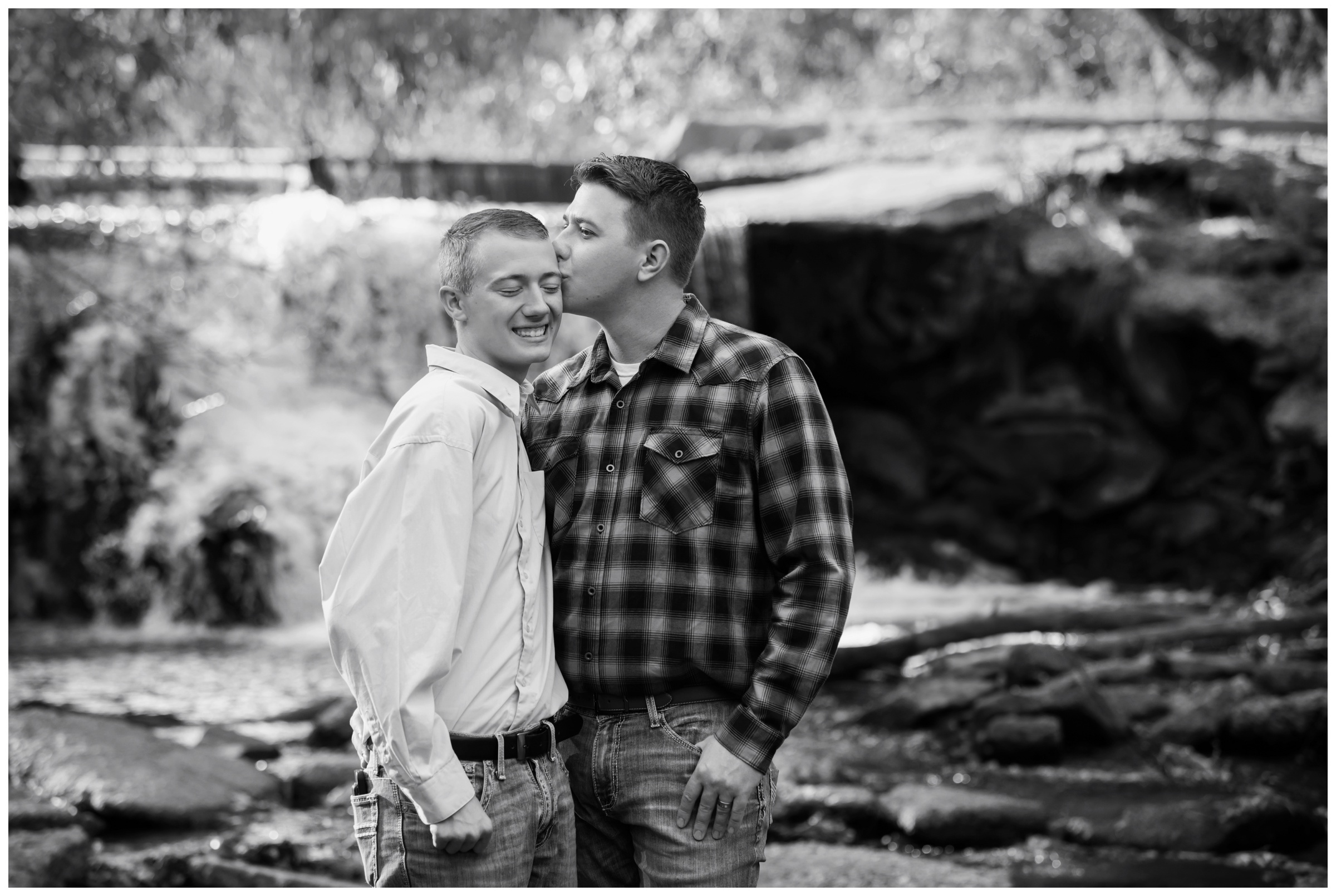 man kissing fiancé during Colorado same sex engagement pictures at Golden Ponds in Longmont