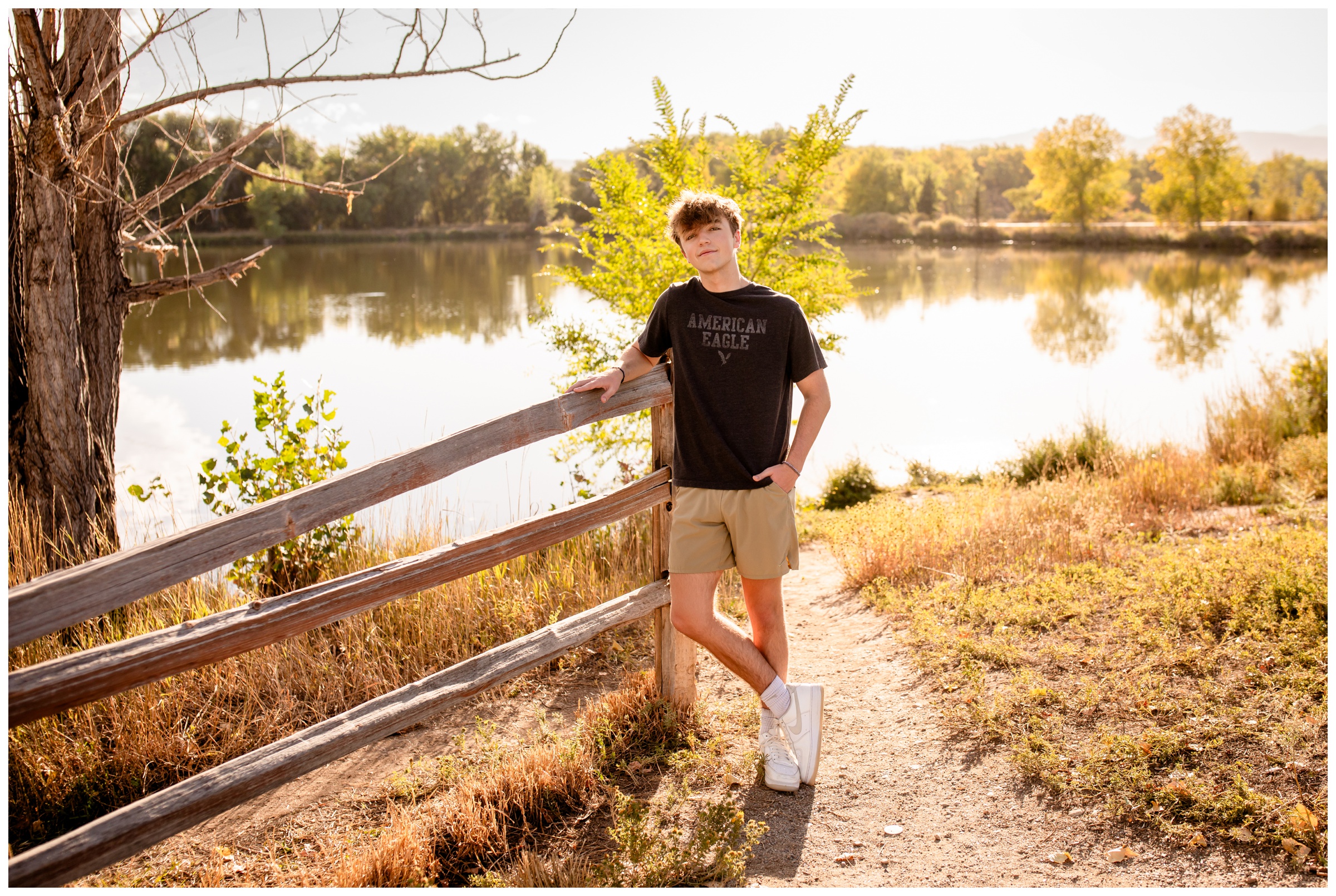 teen leaning on wooden fence at Golden Ponds in Longmont Colorado
