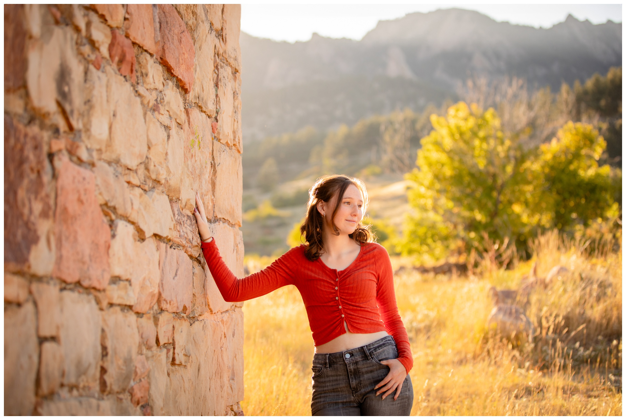 teen posing with flatirons mountains in background at South Mesa in Boulder Colorado