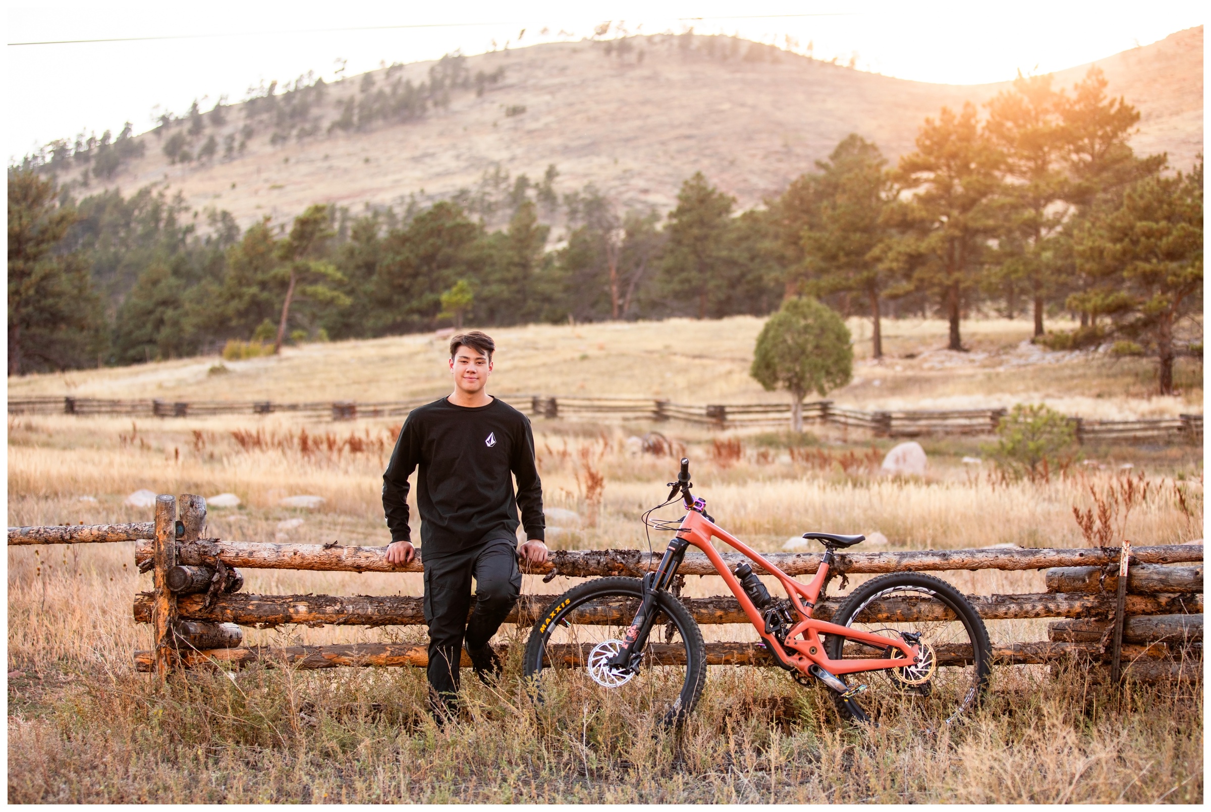 teen guy posing with mountain bike during Niwot High senior portraits in Boulder Colorado