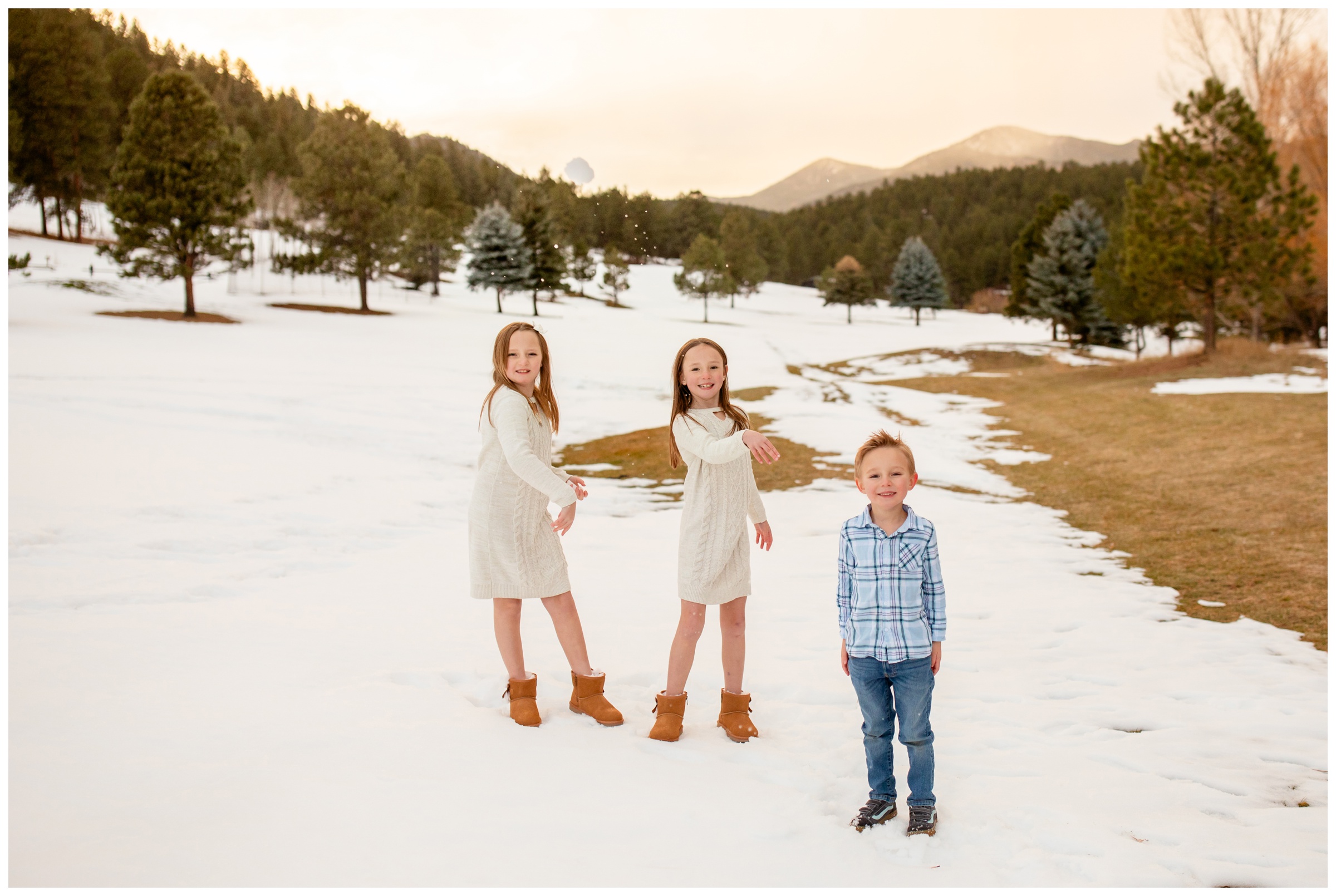 kids throwing snow during candid family photos in Evergreen Colorado