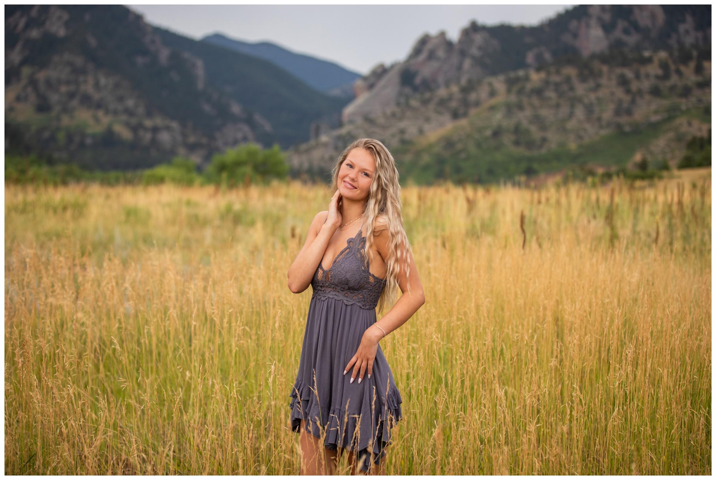 teen posing in field of grass during mountain senior photos in Boulder Colorado