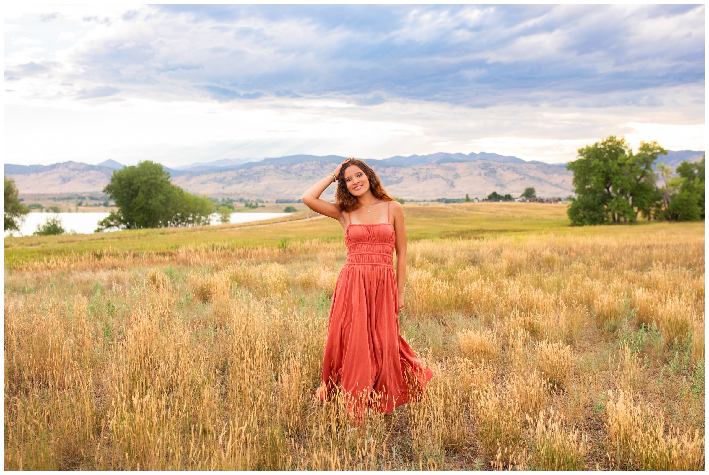 teen twirling in a field during Colorado candid senior photos at Coot Lake 
