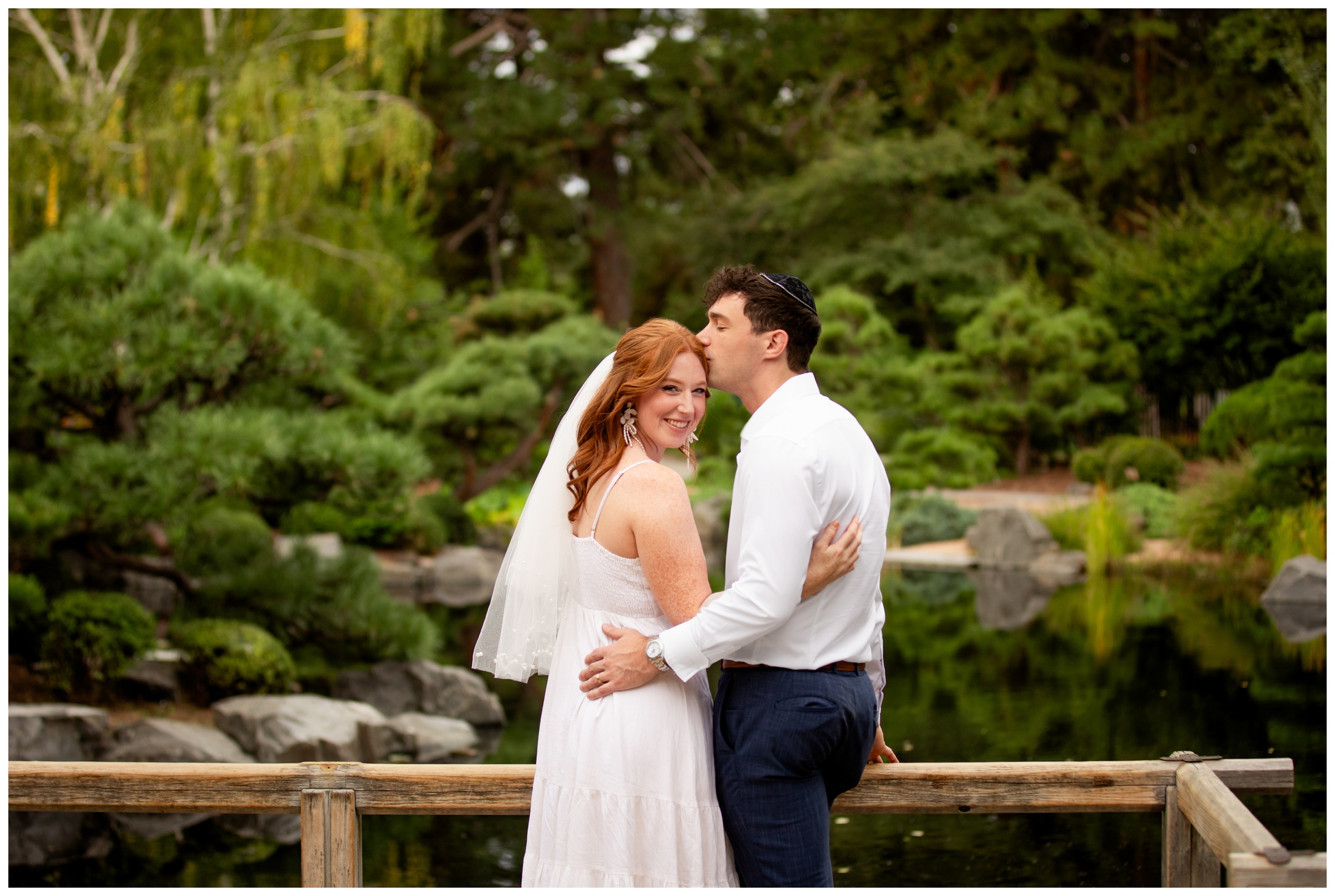 bride and groom posing on dock during garden wedding pictures in Denver Colorado 
