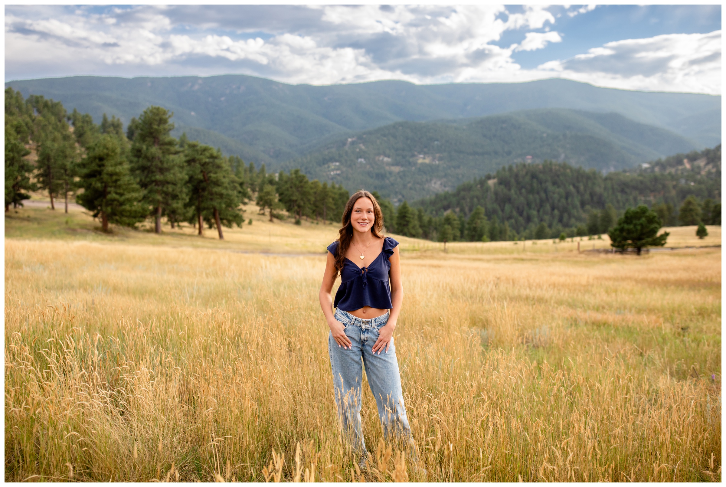 teen posing in mountain field at Betasso Preserve during Boulder Colorado senior pictures