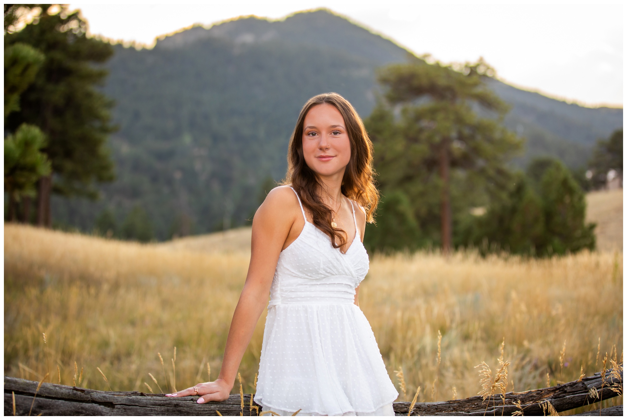 teen leaning against wooden fence during Boulder Colorado mountain senior photos by Plum Pretty Photography 