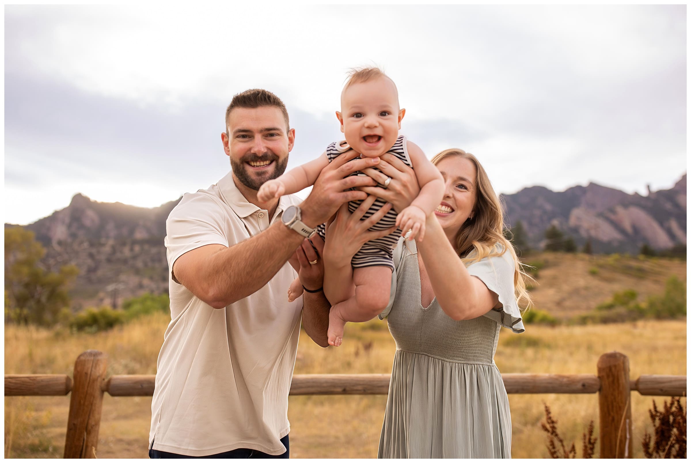 parents swinging son during candid family photos in Boulder Colorado 