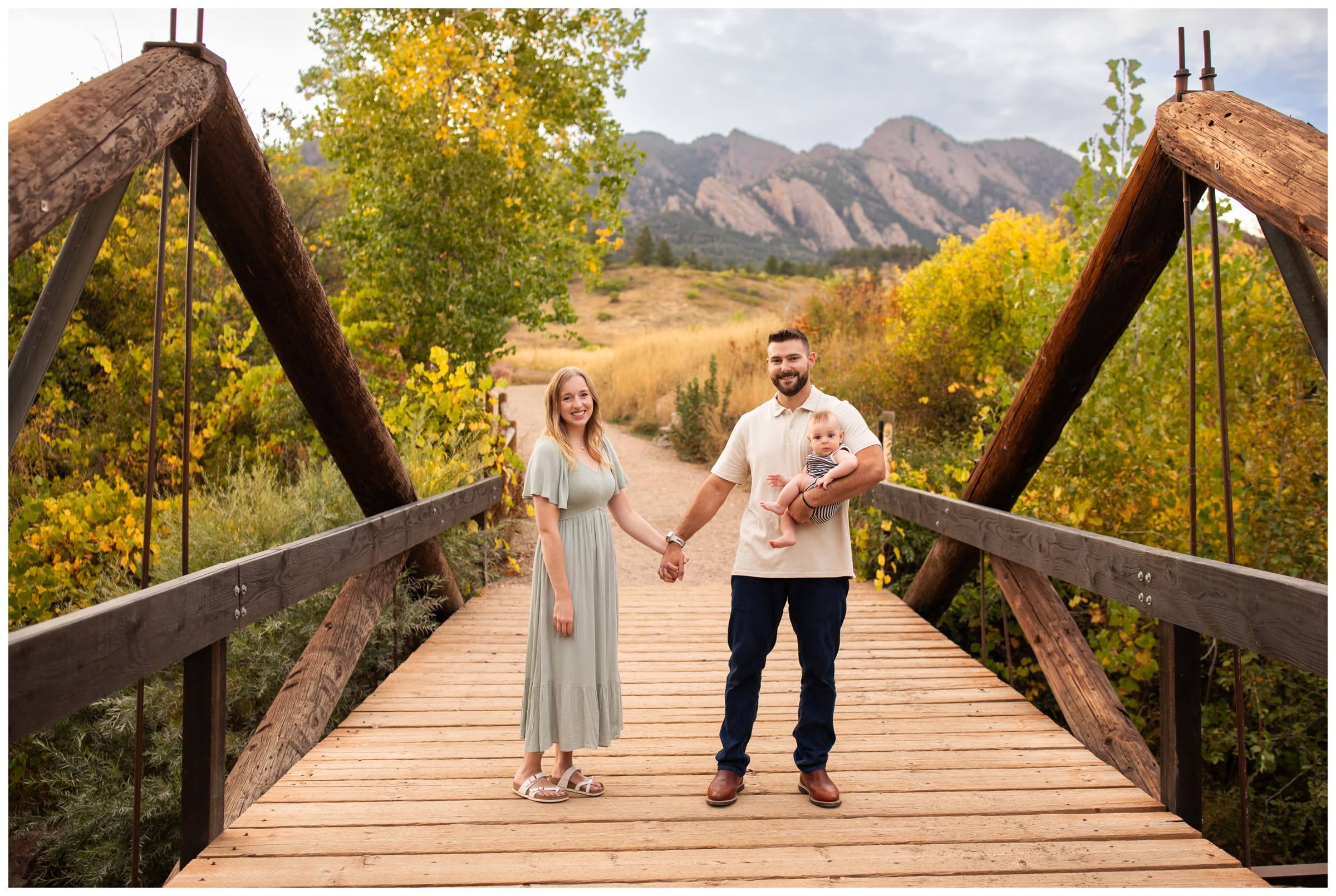 family posing on wooden bridge at South mesa trail in Boulder Colorado 
